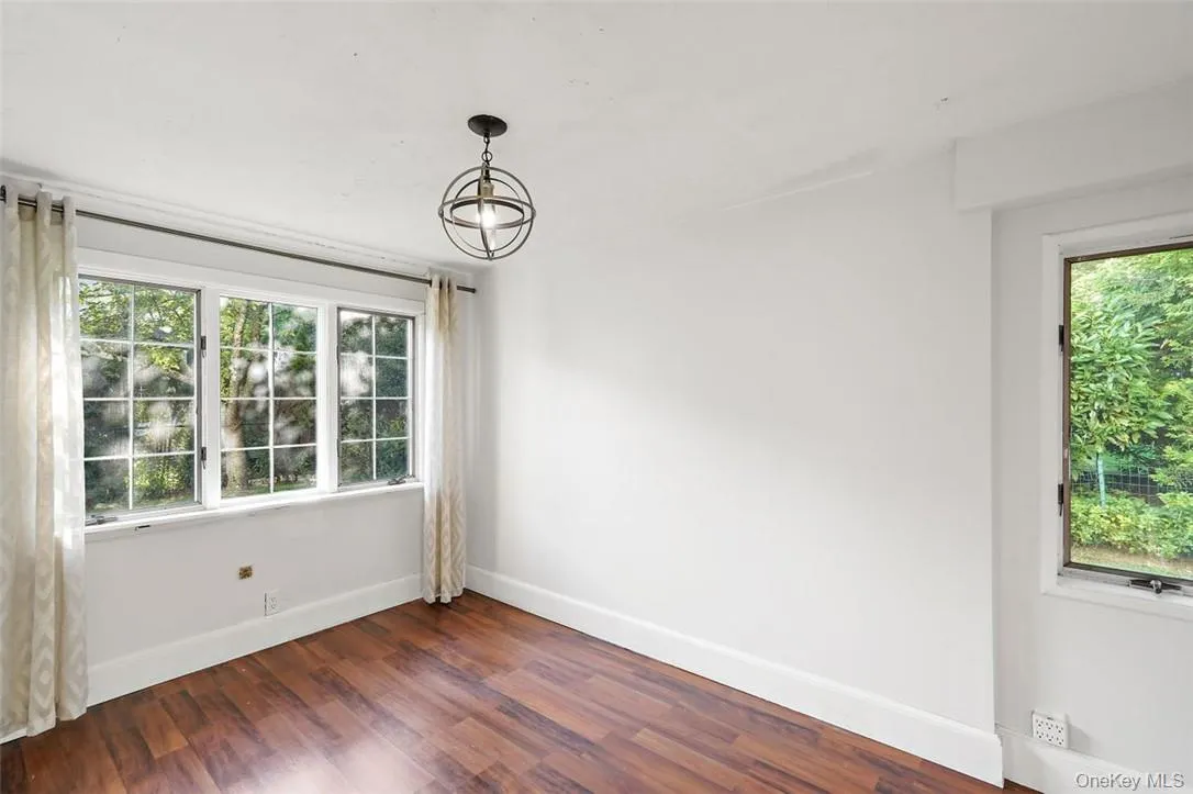 Bonus room / Home office on first floor featuring a wealth of natural light and dark wood finished floors Bonus room / Home office on first floor featuring a wealth of natural light and dark wood finished floors