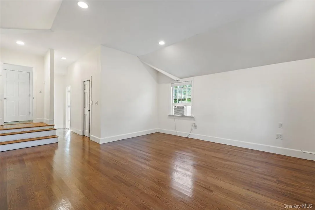 Primary bedroom with high ceilings and beautiful hardwood floors Primary bedroom with high ceilings and beautiful hardwood floors