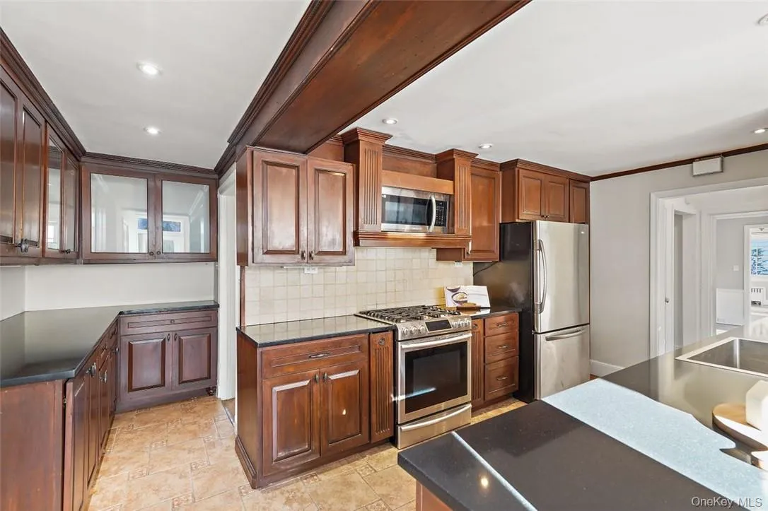 Cherry wood cabinets offer abundant storage Cherry wood cabinets offer abundant storage