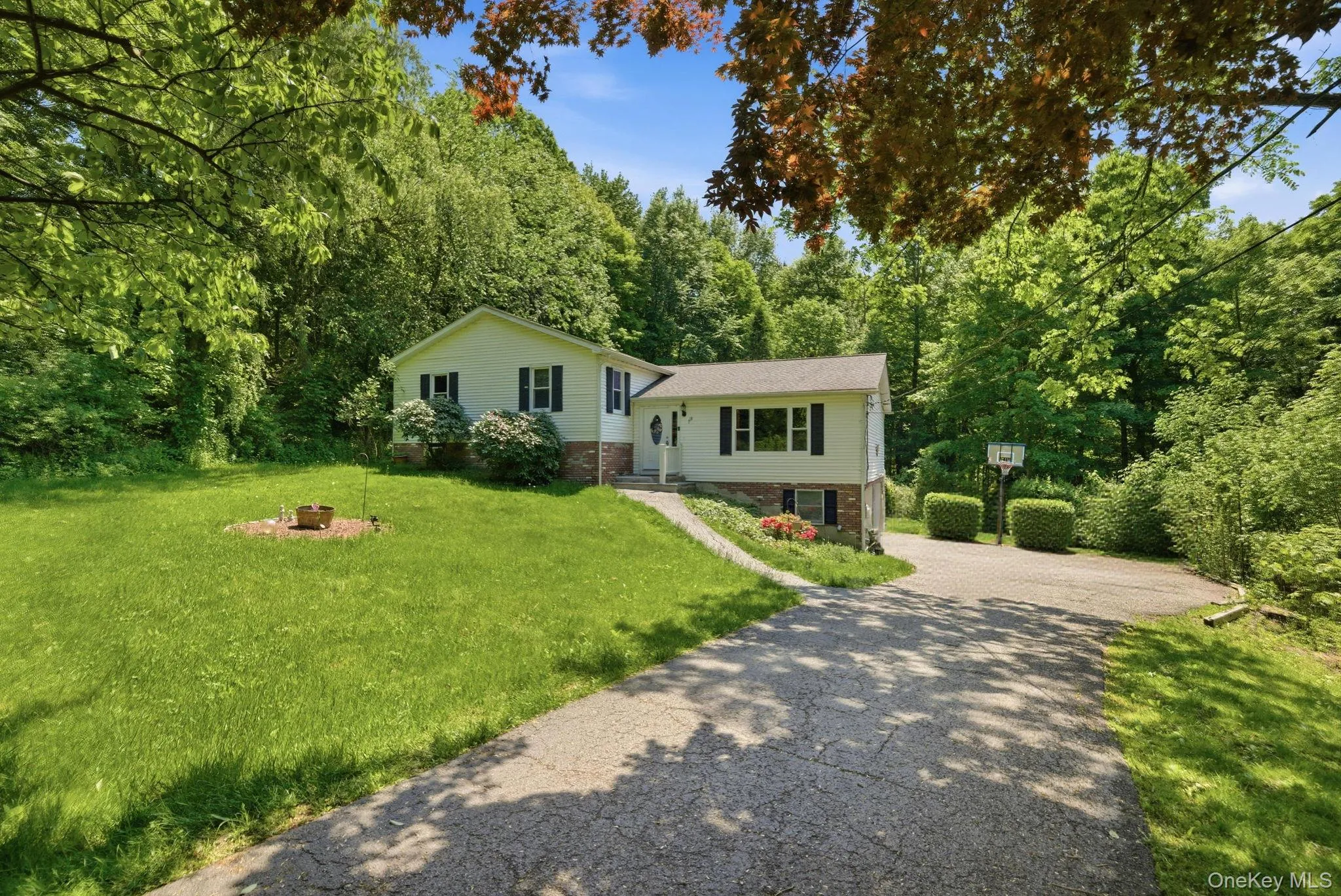 The long driveway and two-car garage offer ample off-street parking and easy access. The long driveway and two-car garage offer ample off-street parking and easy access.