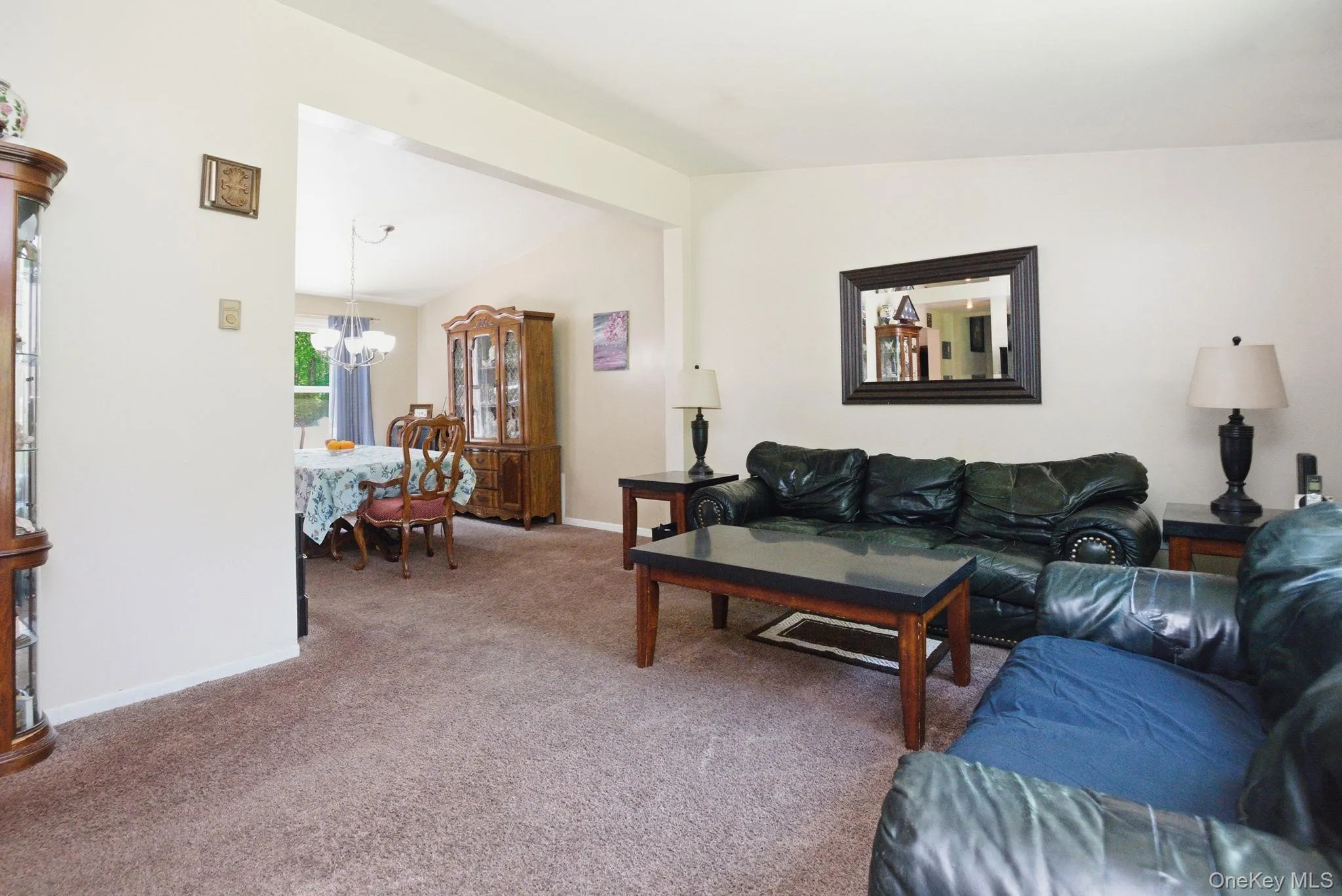 Vaulted ceilings give the living room an open, airy feel, with a natural sightline into the adjoining dining room. Vaulted ceilings give the living room an open, airy feel, with a natural sightline into the adjoining dining room.