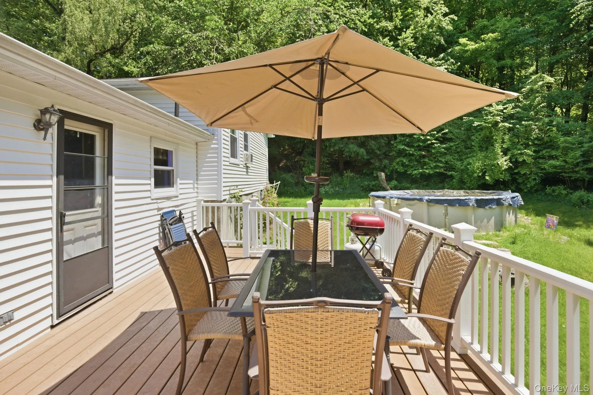 Step out from the main level to a spacious deck, an easy spot for morning coffee or evening grilling surrounded by greenery. Step out from the main level to a spacious deck, an easy spot for morning coffee or evening grilling surrounded by greenery.