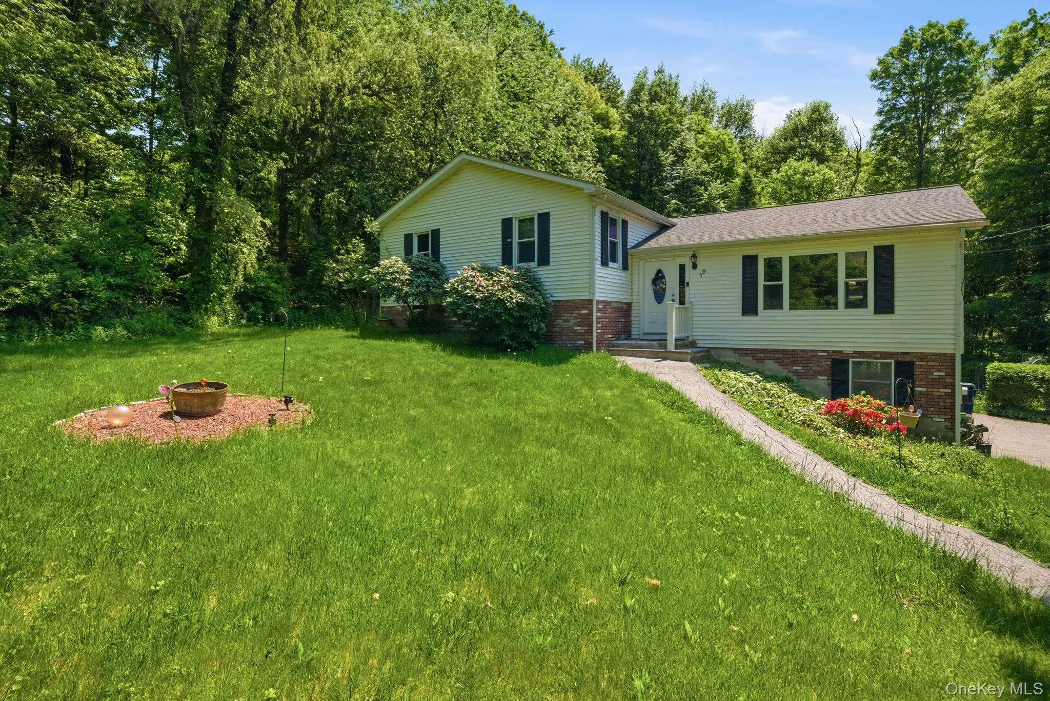 Classic shutters, a brick accent, and blooming front beds give the home charming curb appeal at the end of the drive. Classic shutters, a brick accent, and blooming front beds give the home charming curb appeal at the end of the drive.