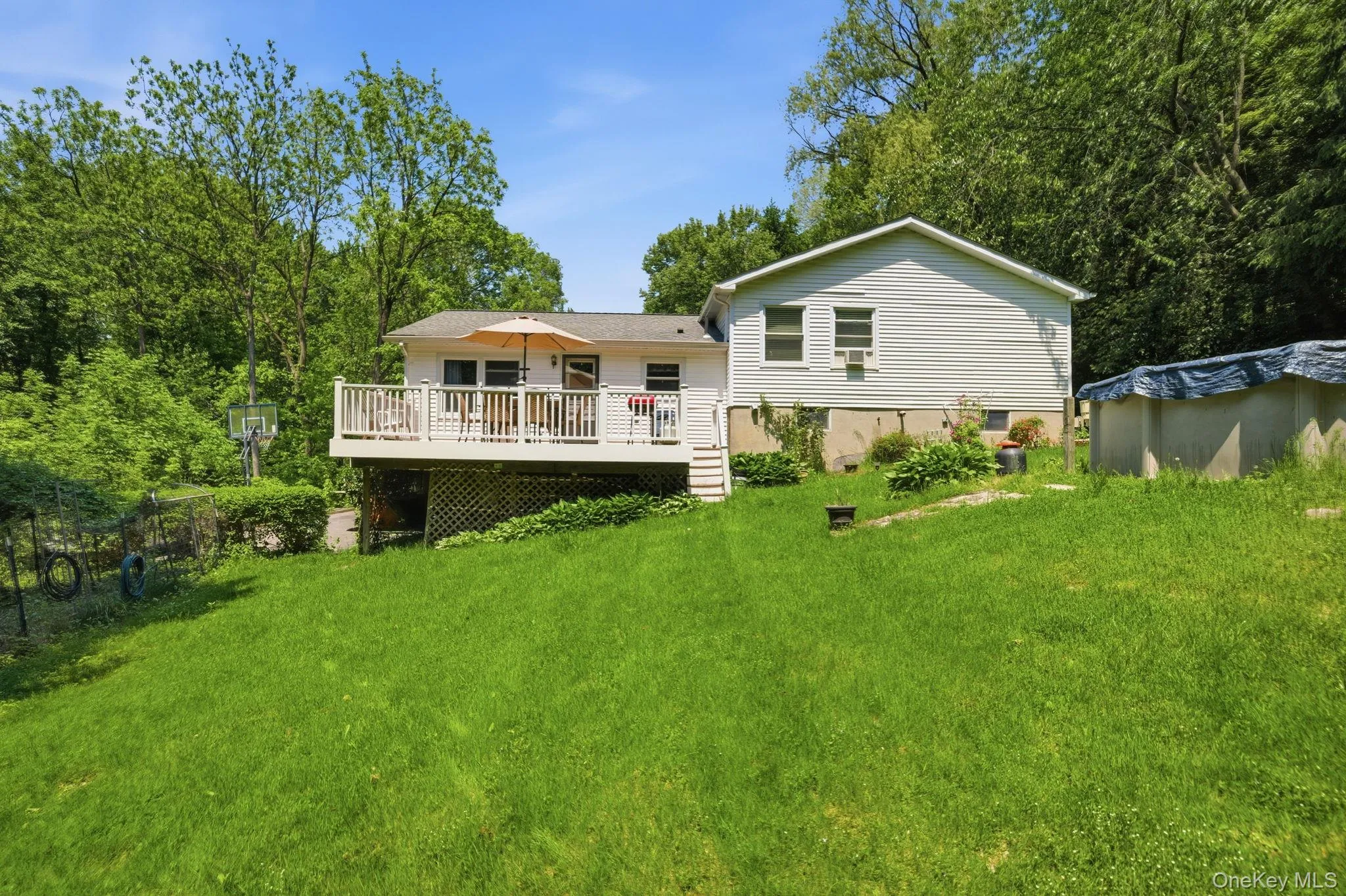 The back of the home opens to a raised deck and a wide, grassy yard with space to garden, play, or simply unwind. The back of the home opens to a raised deck and a wide, grassy yard with space to garden, play, or simply unwind.