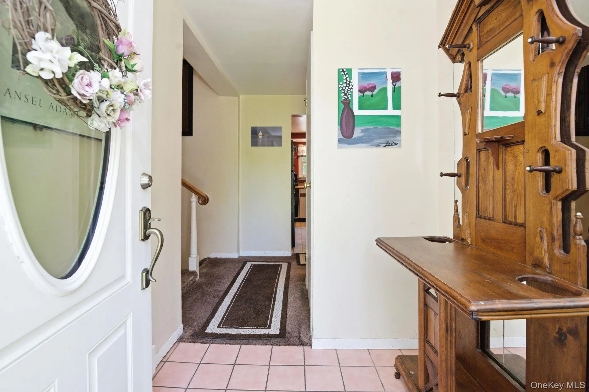 A tiled entry foyer opens to the central staircase connecting all three levels of this split-level layout. A tiled entry foyer opens to the central staircase connecting all three levels of this split-level layout.