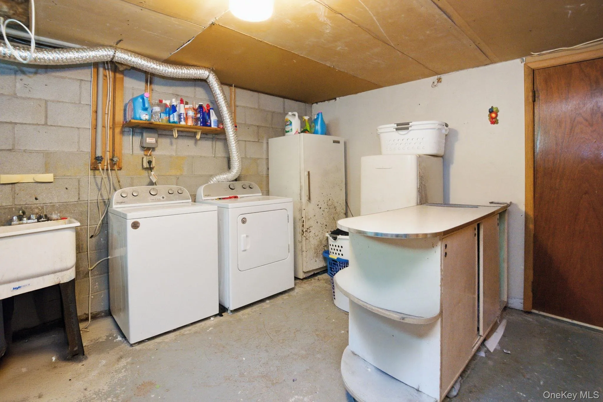 A dedicated laundry room with utility sink offers generous space for storage and workspace, plus room for a workshop area. A dedicated laundry room with utility sink offers generous space for storage and workspace, plus room for a workshop area.