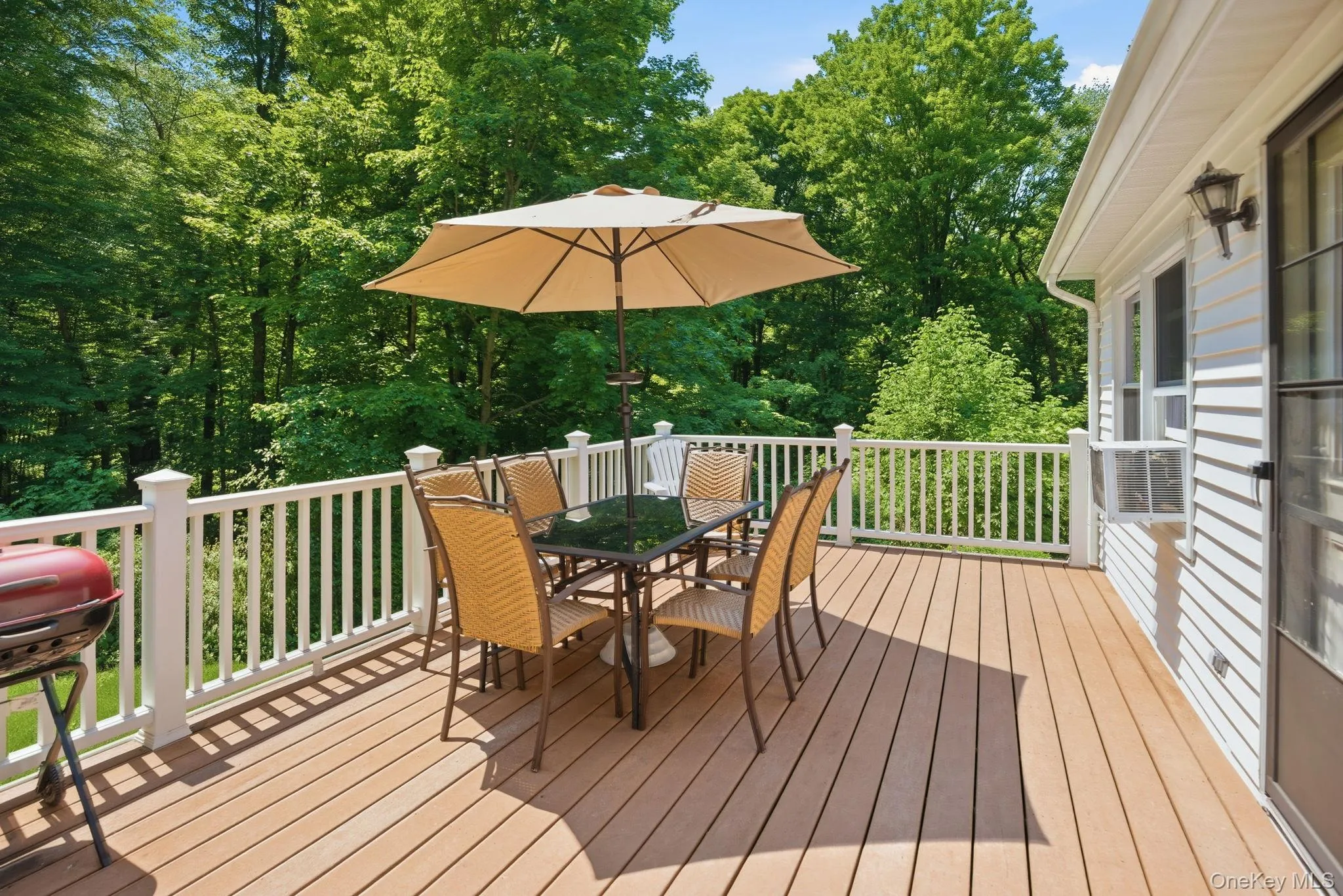 Wrapped in mature trees, the deck delivers a peaceful, secluded backdrop for relaxing or hosting outdoors. Wrapped in mature trees, the deck delivers a peaceful, secluded backdrop for relaxing or hosting outdoors.