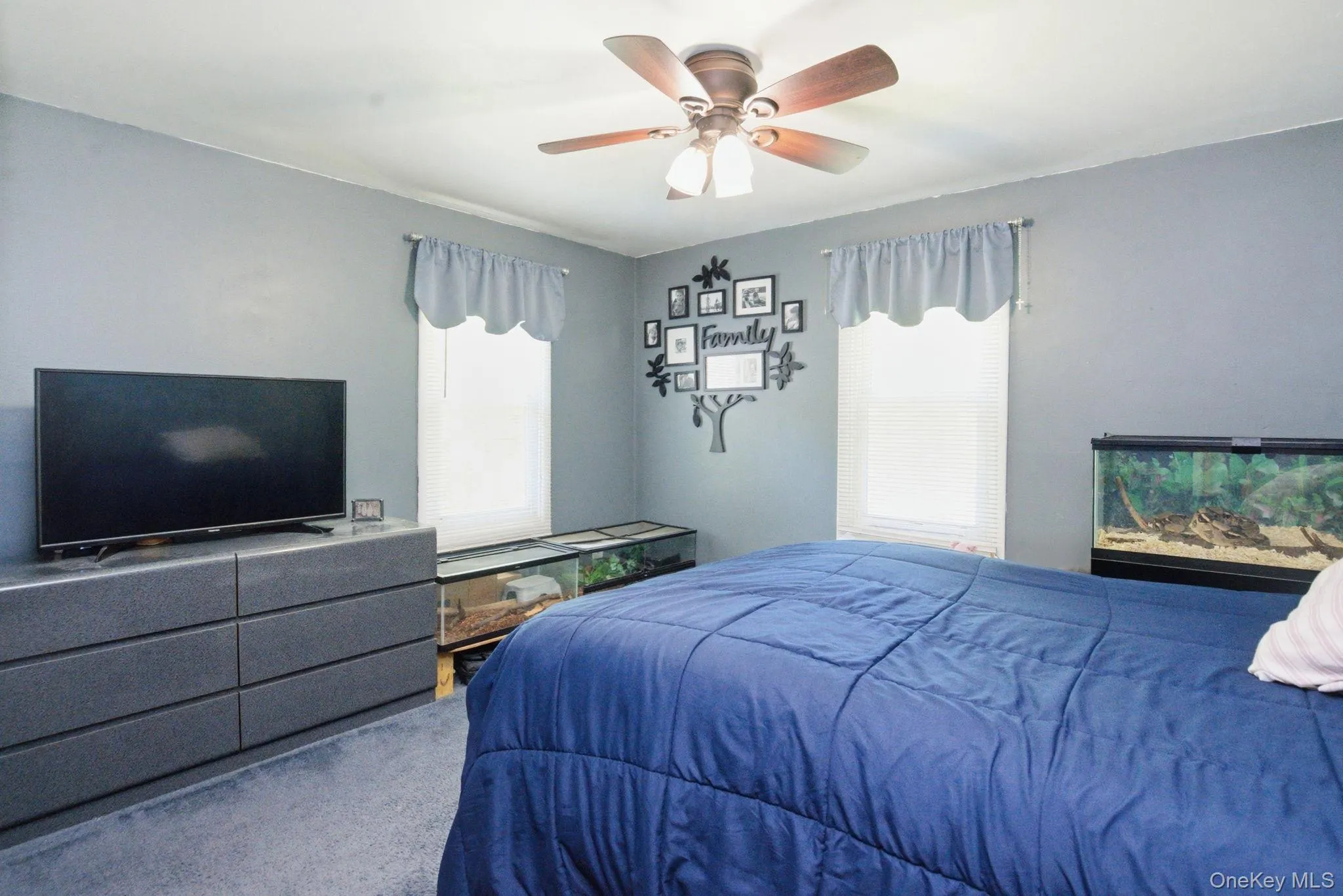 A comfortable bedroom features dual windows and a ceiling fan, with plenty of room for rest or a quiet workspace. A comfortable bedroom features dual windows and a ceiling fan, with plenty of room for rest or a quiet workspace.