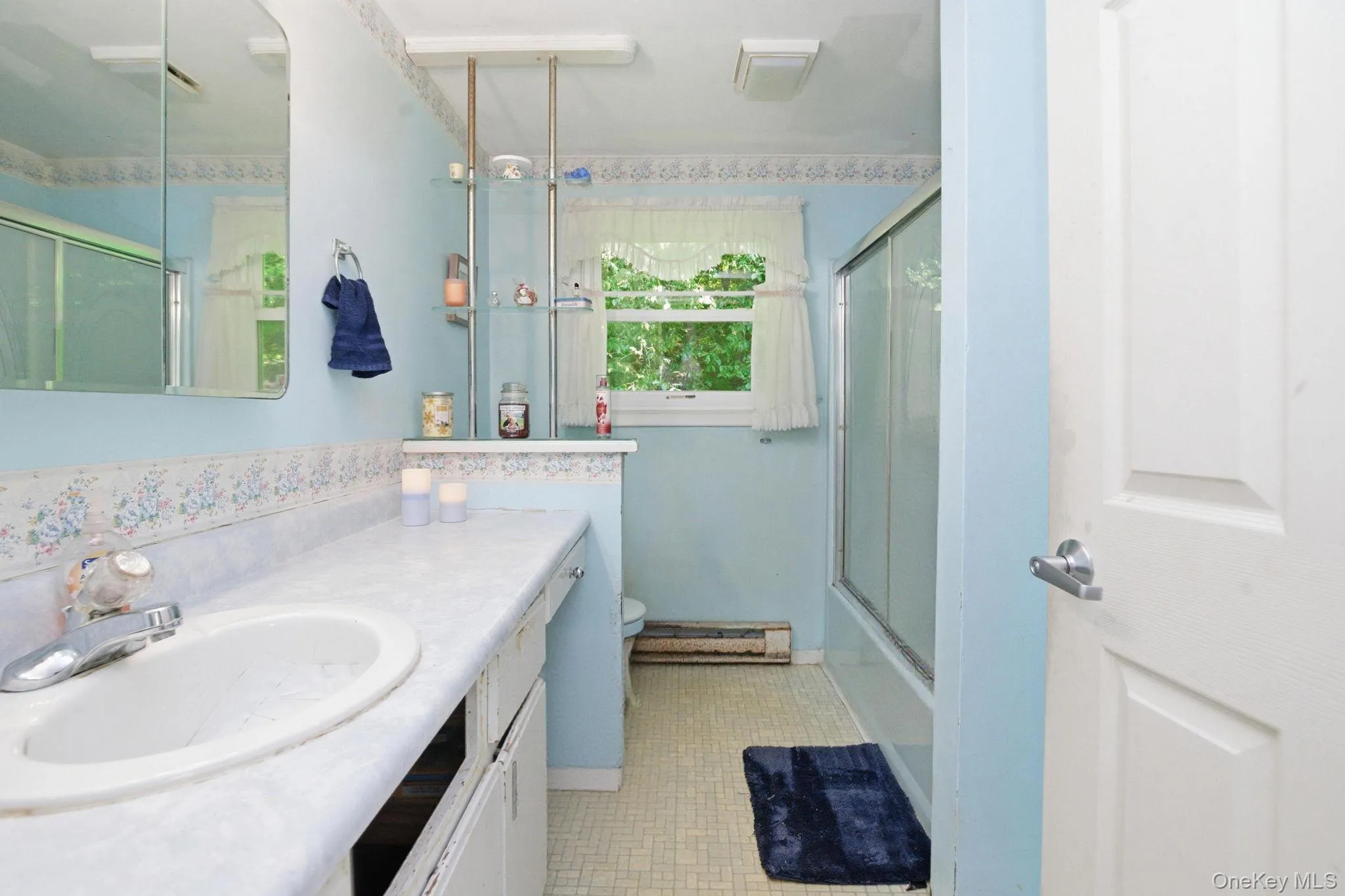 A glass-door shower-tub and heated floor add everyday comfort to this private ensuite, ready for a future refresh. A glass-door shower-tub and heated floor add everyday comfort to this private ensuite, ready for a future refresh.