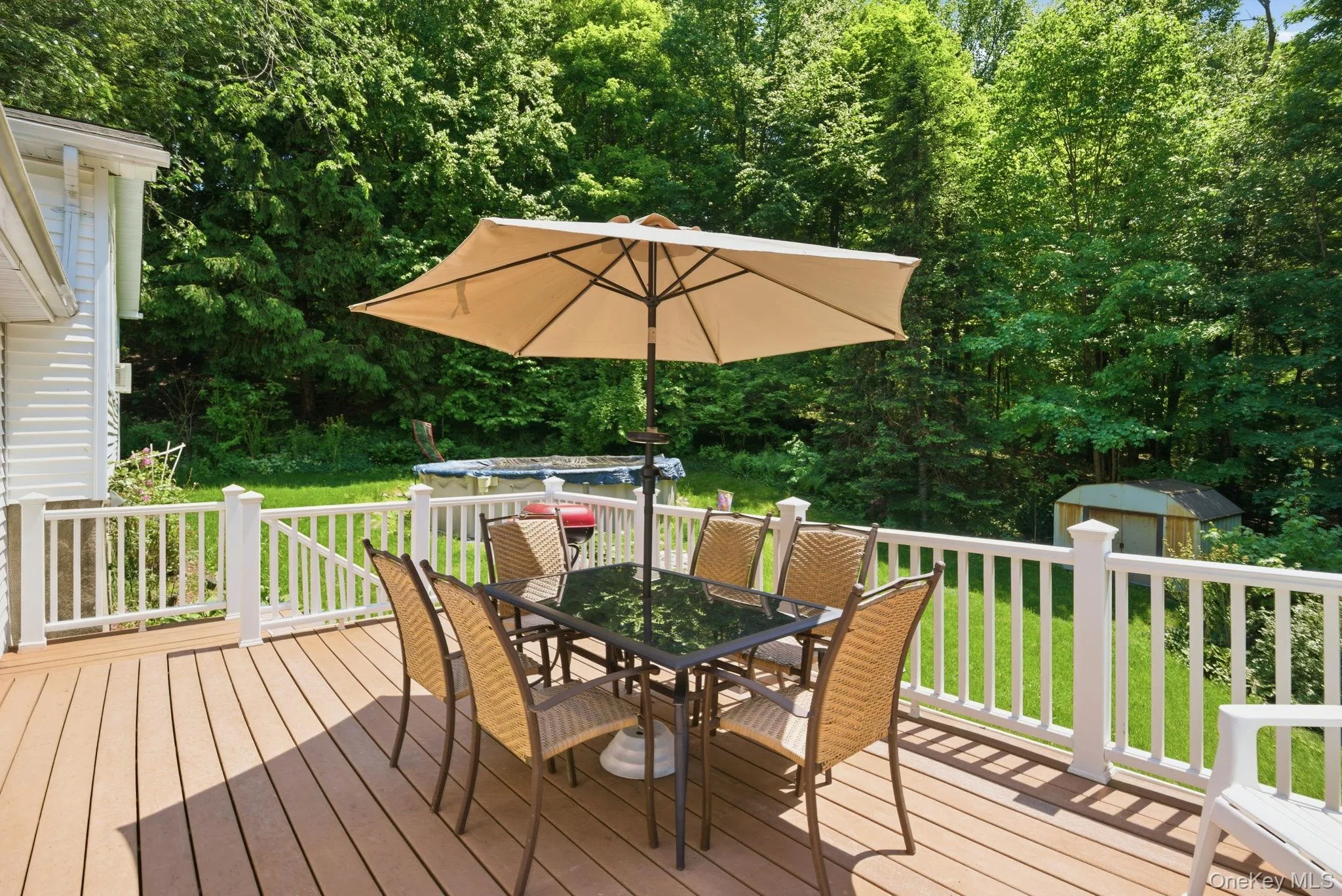 The expansive deck overlooks the backyard and pool, offering plenty of room for outdoor dining and summer entertaining. The expansive deck overlooks the backyard and pool, offering plenty of room for outdoor dining and summer entertaining.