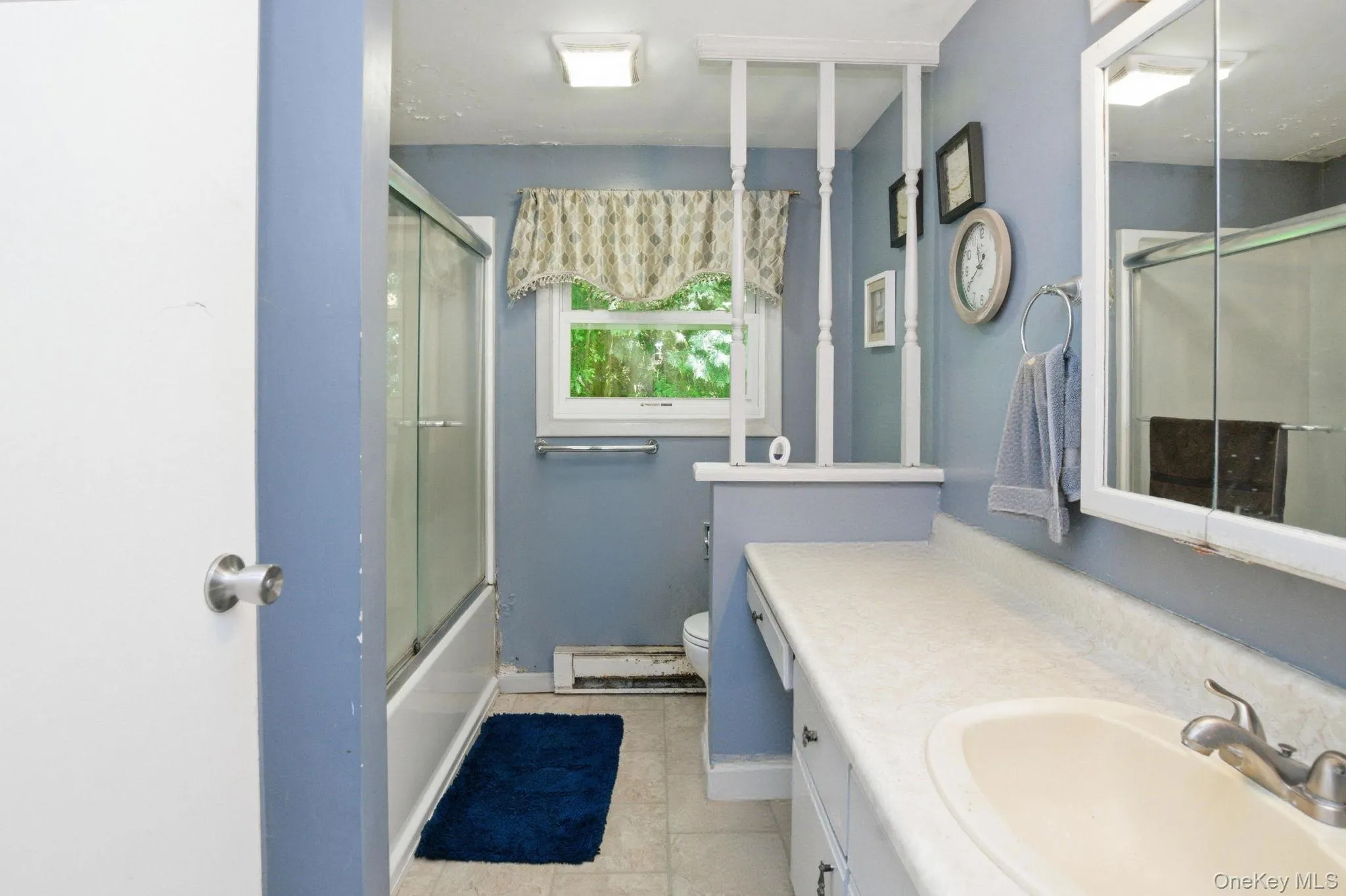 A glass-enclosed shower-tub and a practical layout make this hall bath an easy daily-use space with room to update over time. A glass-enclosed shower-tub and a practical layout make this hall bath an easy daily-use space with room to update over time.