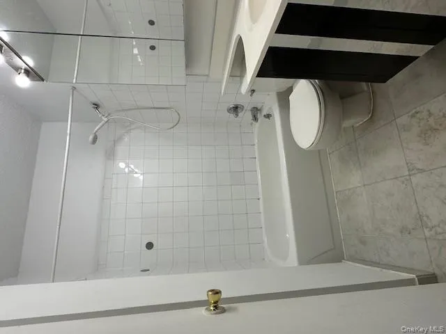 Bathroom featuring vanity and shower / bath combination Bathroom featuring vanity and shower / bath combination