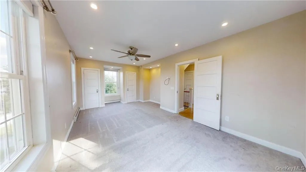 Unfurnished bedroom featuring light colored carpet, recessed lighting, ceiling fan, and access to outside Unfurnished bedroom featuring light colored carpet, recessed lighting, ceiling fan, and access to outside