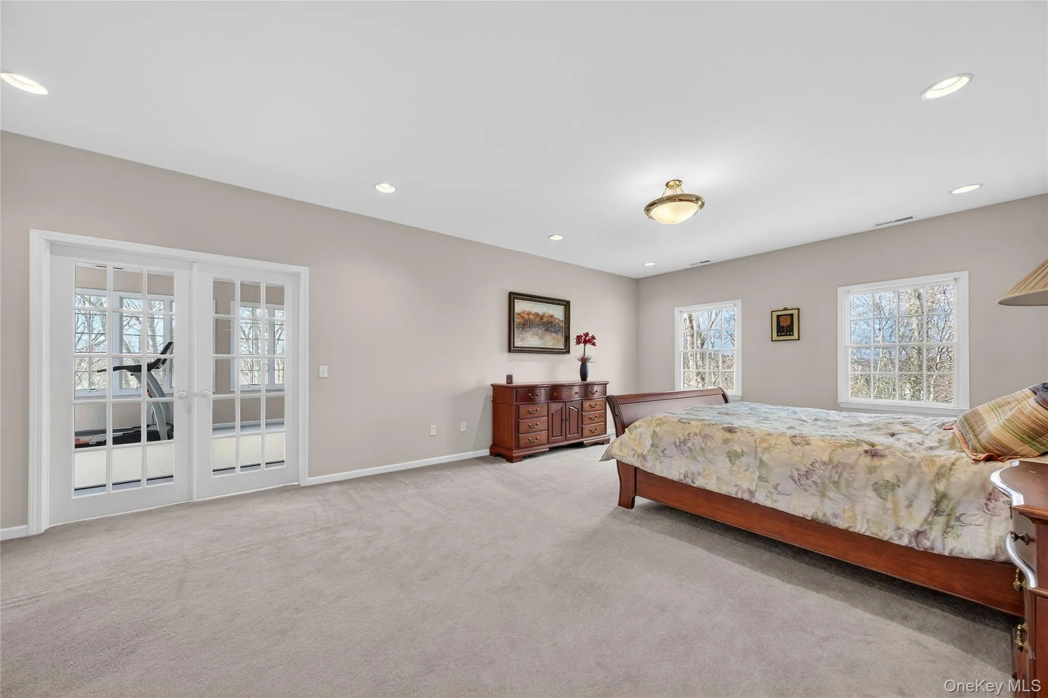 The spacious primary bedroom offers two walk-in closets, a primary bathroom and door to a large sunroom. The spacious primary bedroom offers two walk-in closets, a primary bathroom and door to a large sunroom.