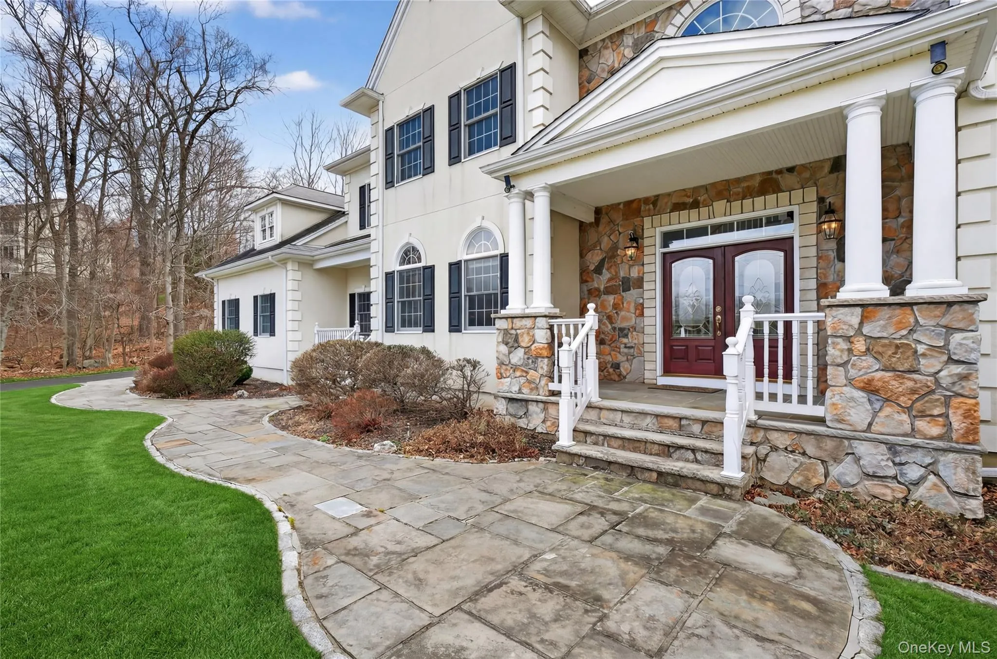 A stone walkway and front porch introduce this beautiful house. A stone walkway and front porch introduce this beautiful house.