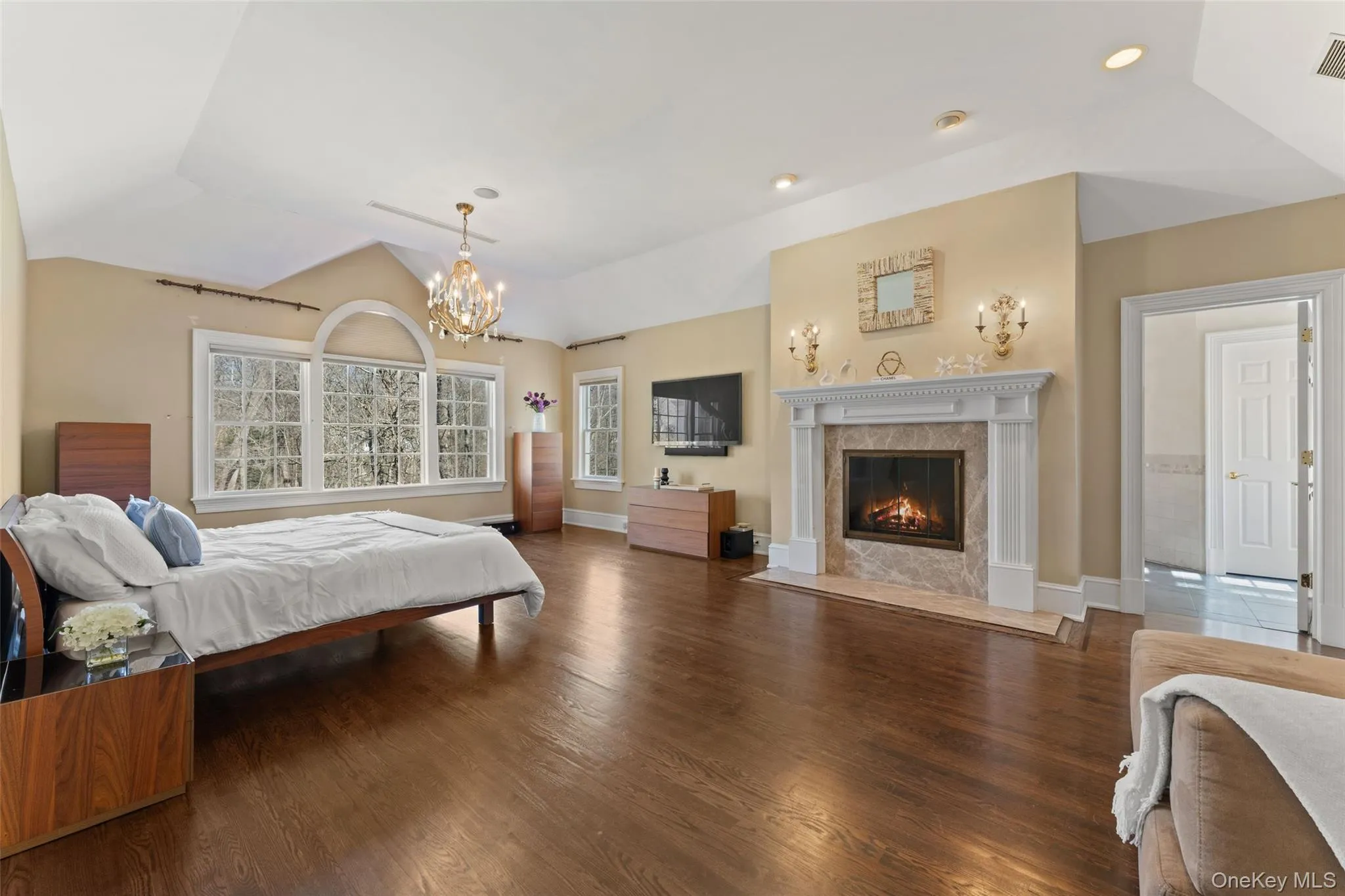 Palatial owner’s retreat with a fireplace and custom walk-in closets Palatial owner’s retreat with a fireplace and custom walk-in closets