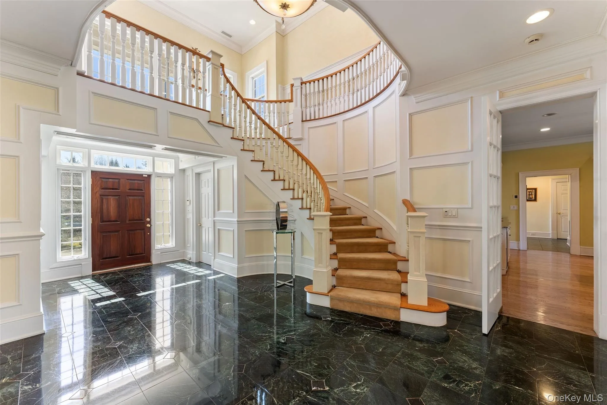 The soaring double-height foyer and sweeping curved staircase create a dramatic first impression The soaring double-height foyer and sweeping curved staircase create a dramatic first impression