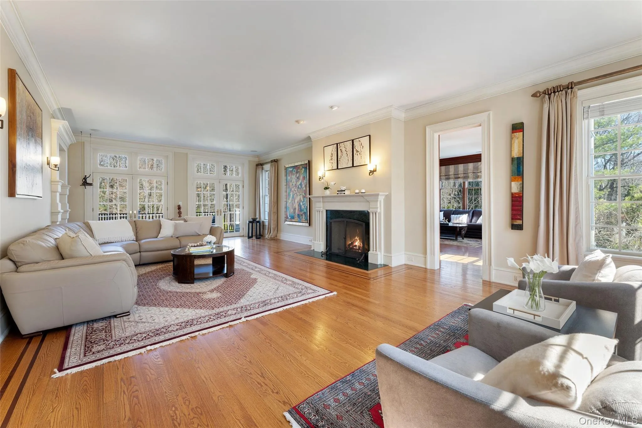 Lavish formal living room with French doors and wood burning fireplace Lavish formal living room with French doors and wood burning fireplace