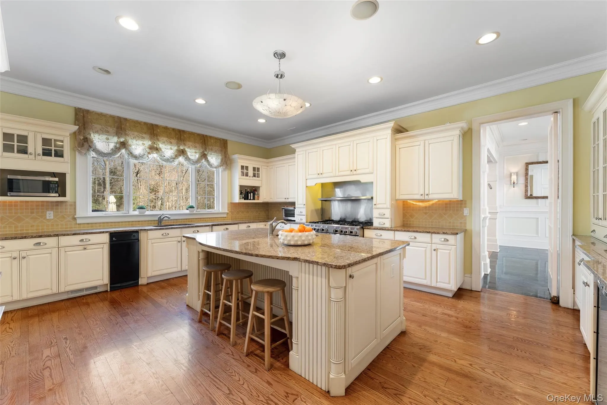 Professional-grade chef's kitchen with high-end appliances, including eight-burner DCS range and two Sub-Zero refrigerators Professional-grade chef's kitchen with high-end appliances, including eight-burner DCS range and two Sub-Zero refrigerators