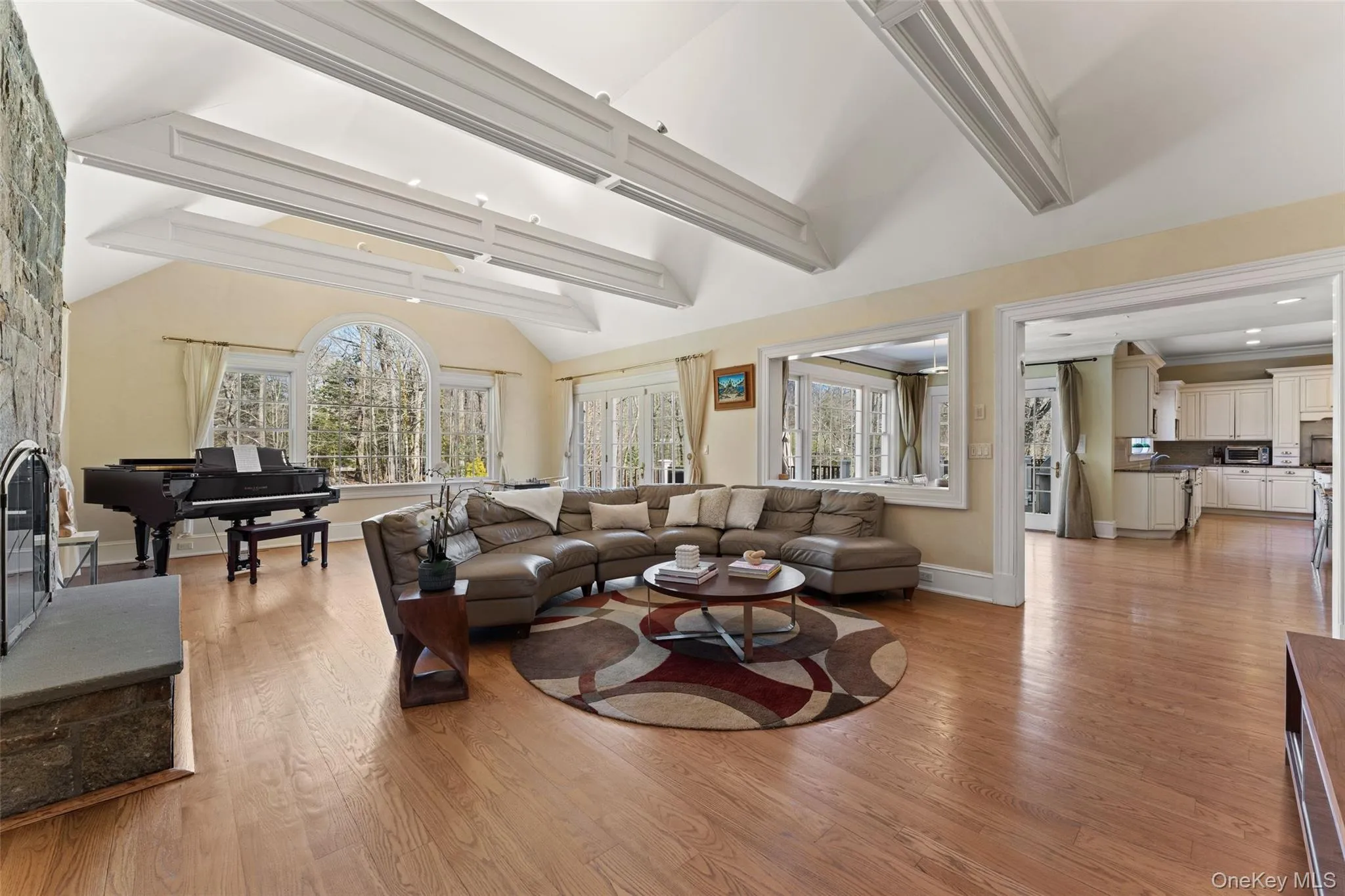 Expansive vaulted family room with a stone fireplace Expansive vaulted family room with a stone fireplace