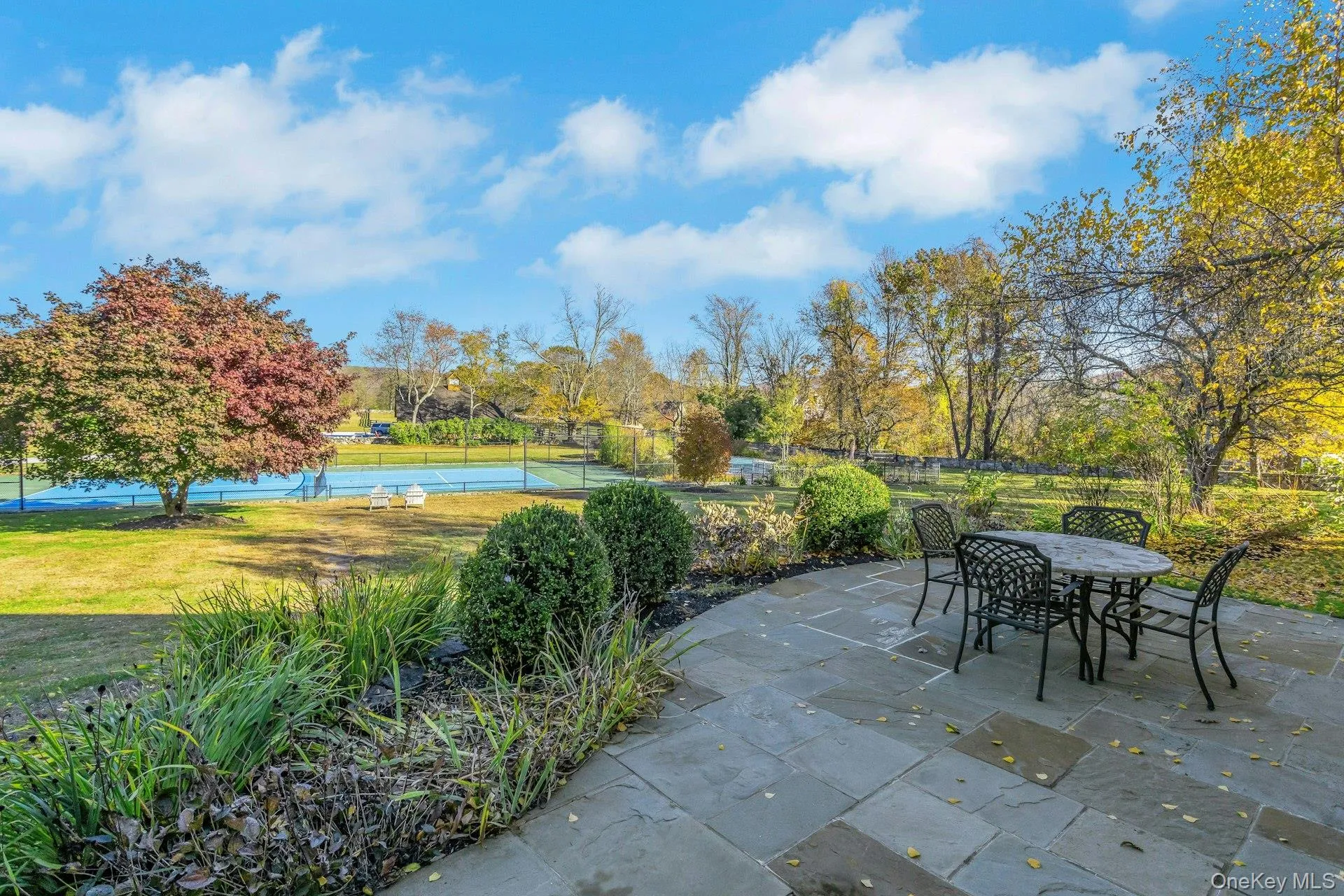View of patio / terrace with a tennis court and outdoor dining area View of patio / terrace with a tennis court and outdoor dining area