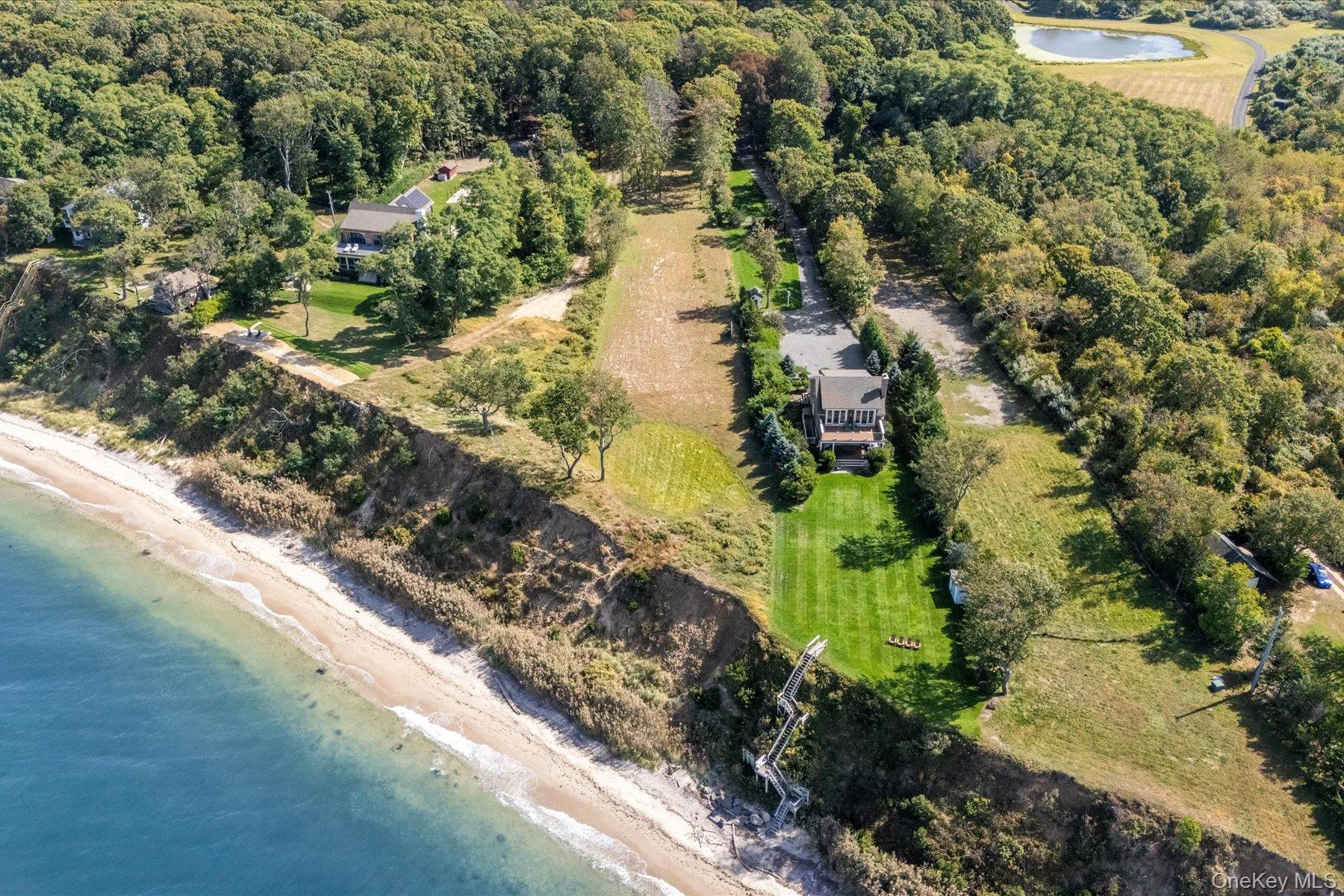Aerial view of property and surrounding area with unending shoreline and property boundaries highlighted Aerial view of property and surrounding area with unending shoreline and property boundaries highlighted