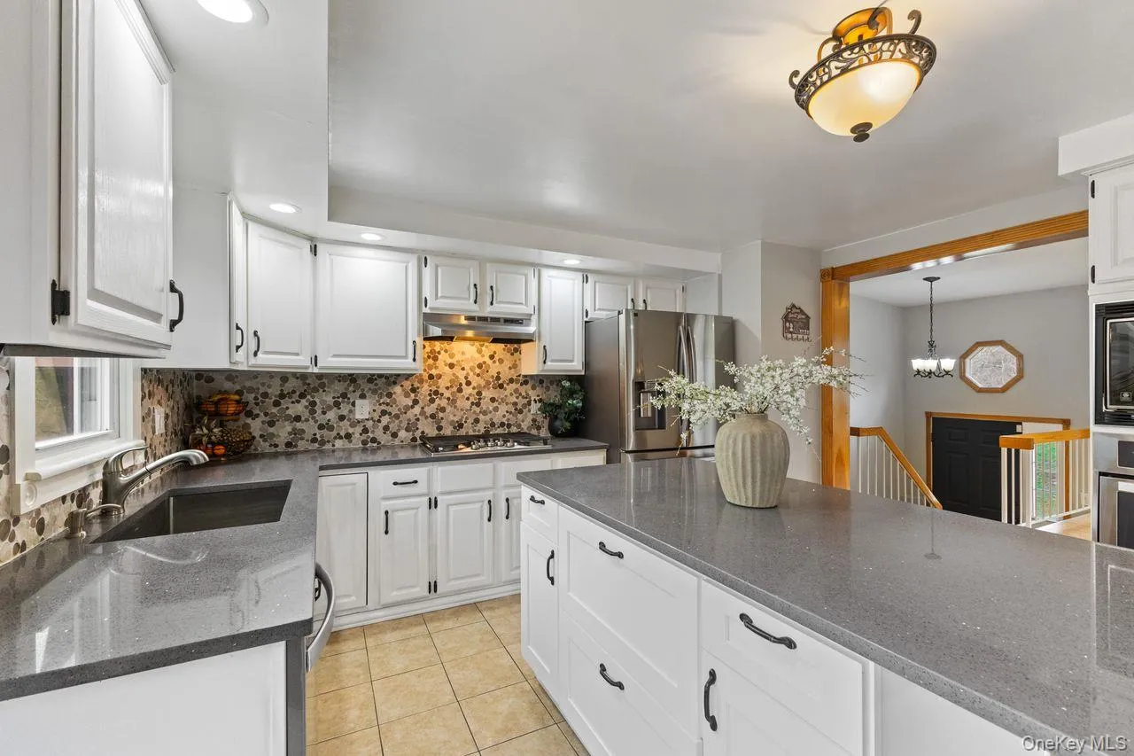 Main floor kitchen. Updated with Quartz countertop center island and stainless steel appliances including 5 burner gas cooktop. Main floor kitchen. Updated with Quartz countertop center island and stainless steel appliances including 5 burner gas cooktop.