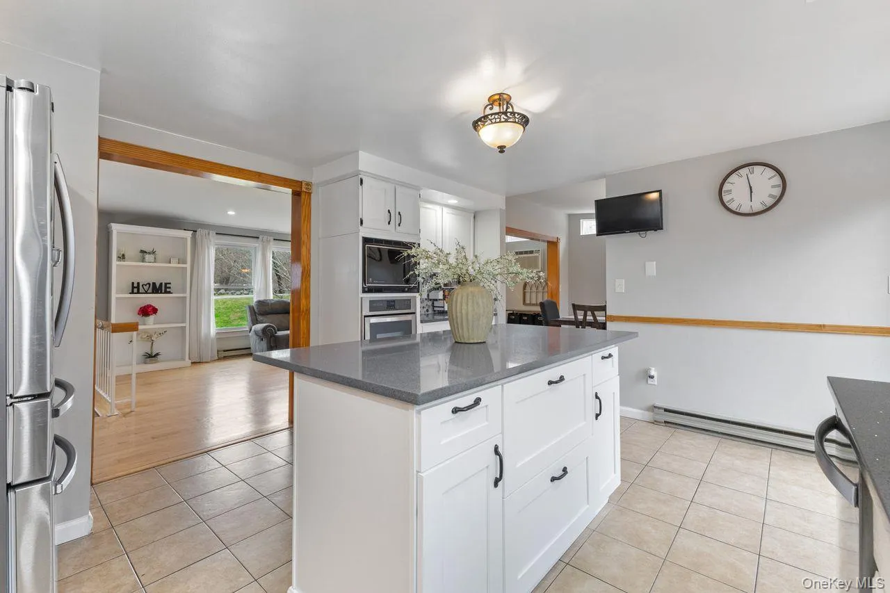 Main floor kitchen. Updated with Quartz countertop center island and stainless steel appliances including 5 burner gas cooktop. Main floor kitchen. Updated with Quartz countertop center island and stainless steel appliances including 5 burner gas cooktop.