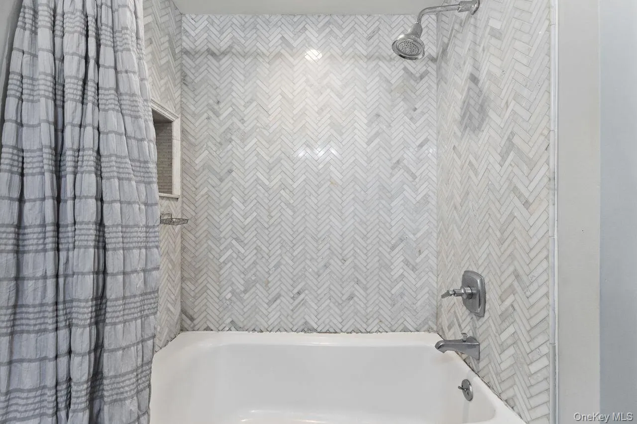 Beautiful herringbone tiled shower/tub combo. Beautiful herringbone tiled shower/tub combo.