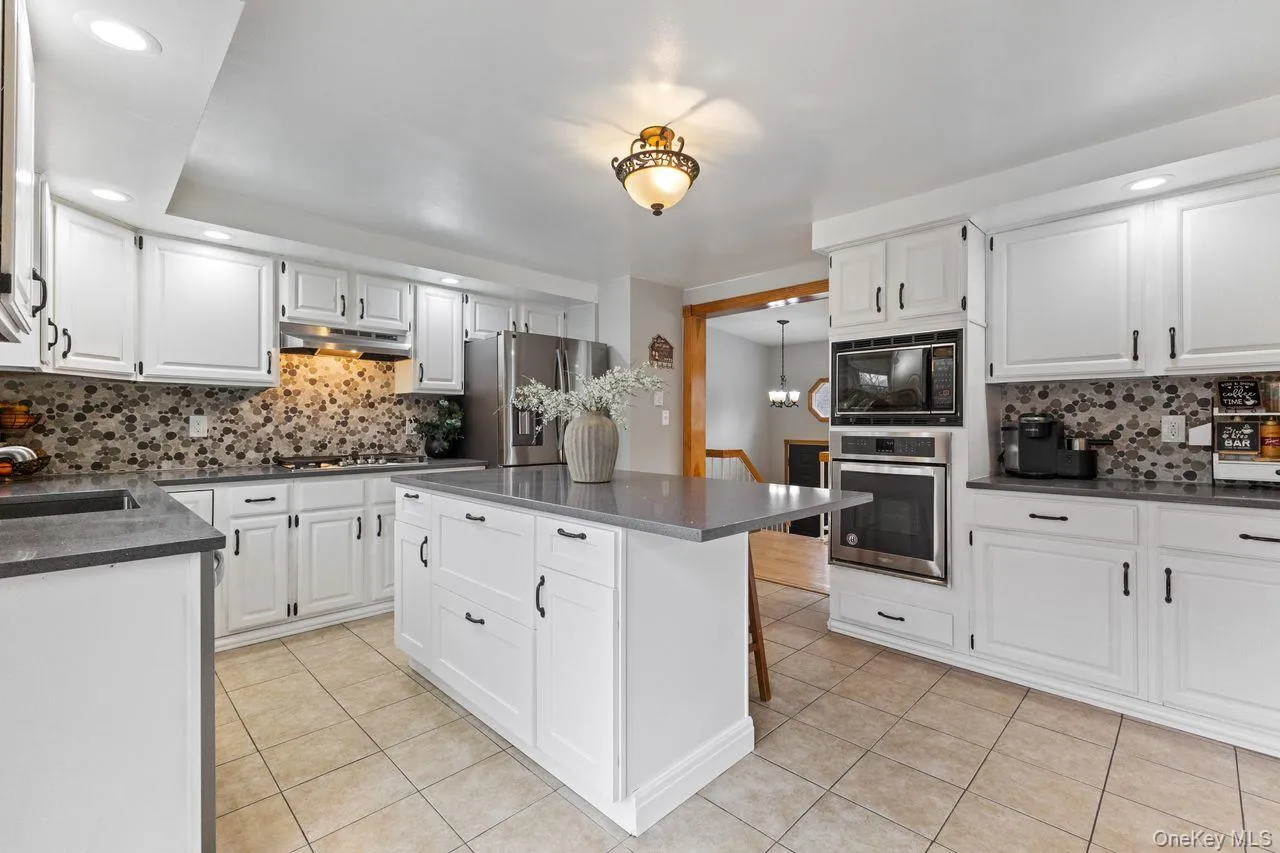 Main floor kitchen. Updated with Quartz countertop center island and stainless steel appliances including 5 burner gas cooktop. Main floor kitchen. Updated with Quartz countertop center island and stainless steel appliances including 5 burner gas cooktop.