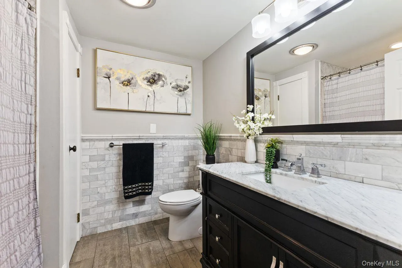 Updated hall bathroom with natural stone tile. Updated hall bathroom with natural stone tile.