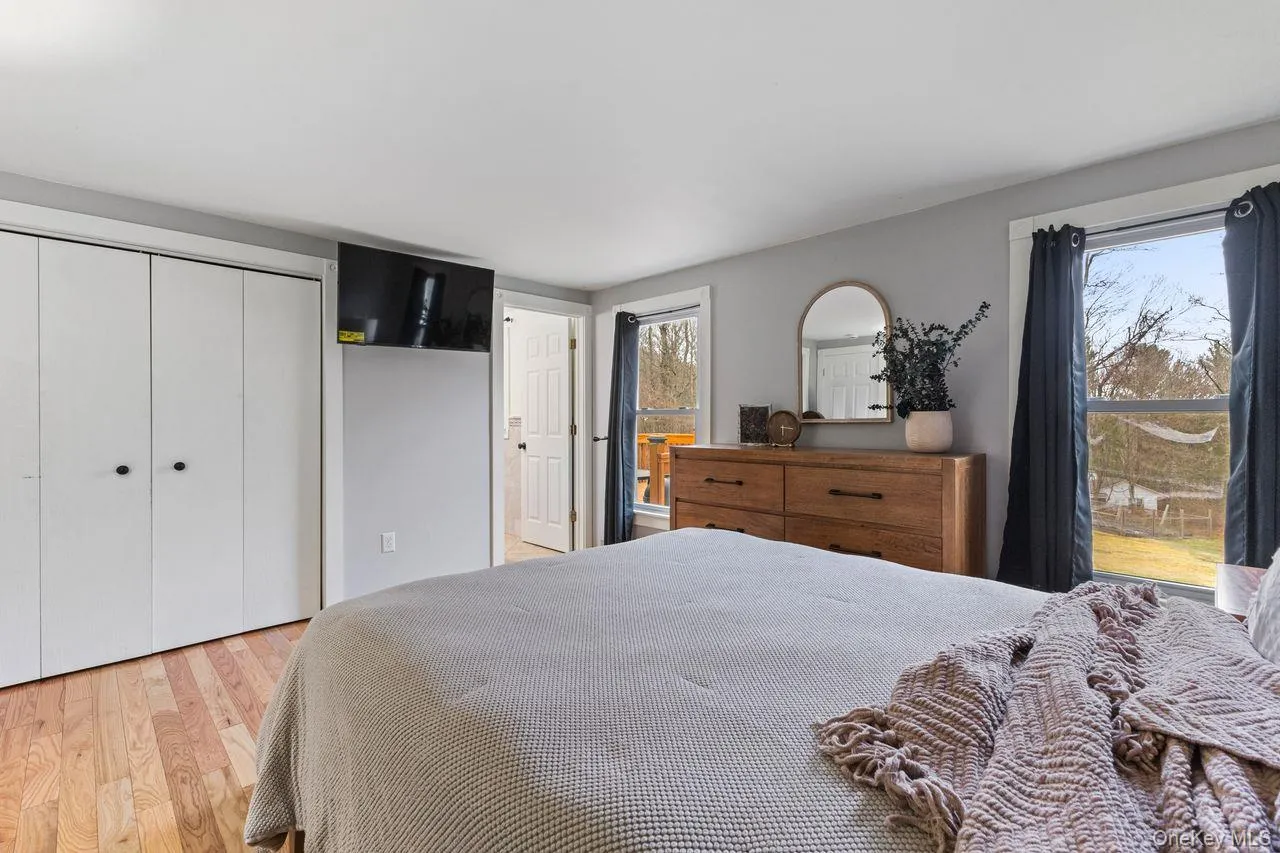 Large primary bedroom with new hardwood floors. Large primary bedroom with new hardwood floors.