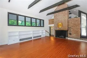 Wood burining fireplace under a brick wall design Wood burining fireplace under a brick wall design