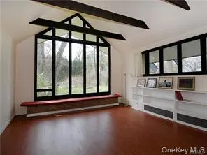 Great room featuring beamed ceiling and built in book shelves Great room featuring beamed ceiling and built in book shelves