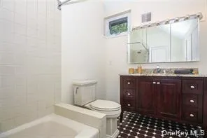 Full bath featuring vanity, a bath, and a shower Full bath featuring vanity, a bath, and a shower