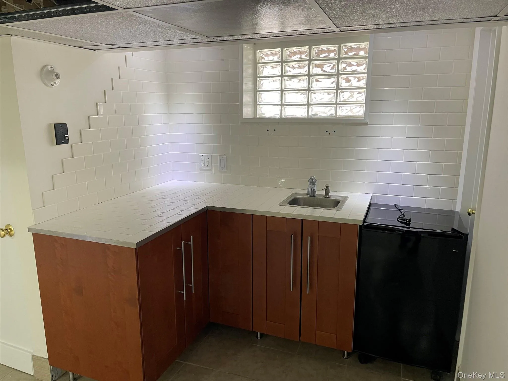 Basement sink w/ cabinets and mini fridge Basement sink w/ cabinets and mini fridge