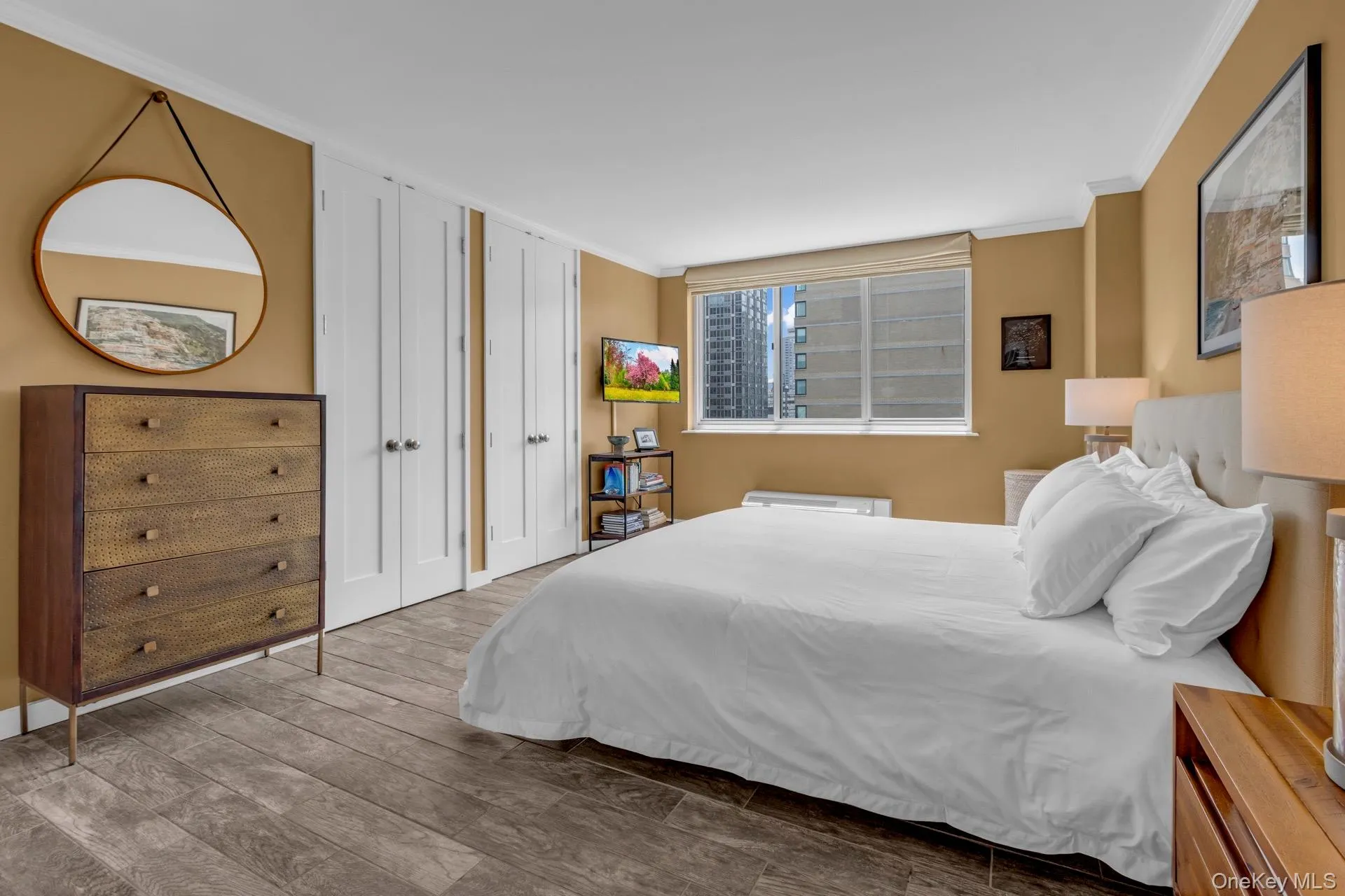 Bedroom with crown molding and wood finished floors Bedroom with crown molding and wood finished floors