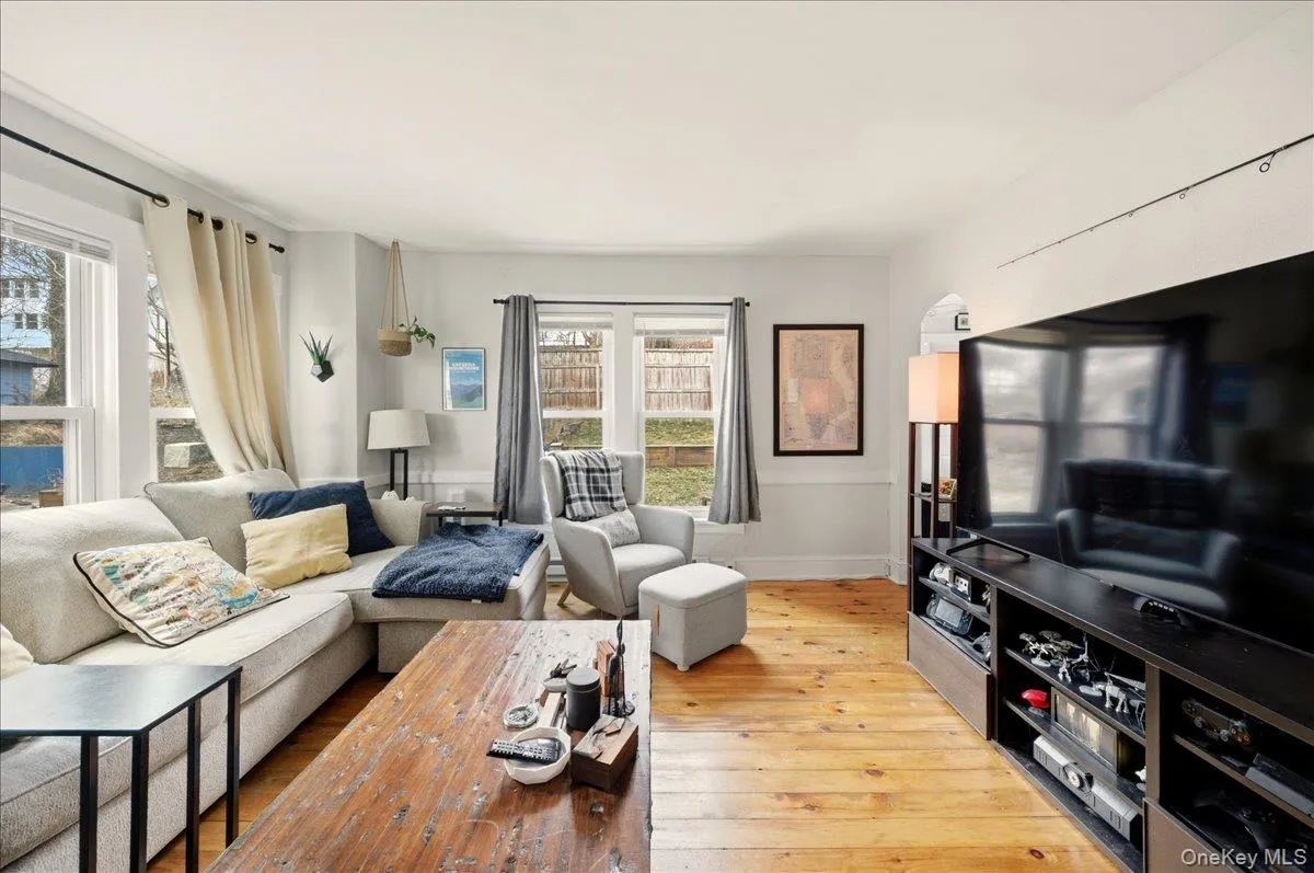 Living area with light wood-type flooring and baseboards Living area with light wood-type flooring and baseboards