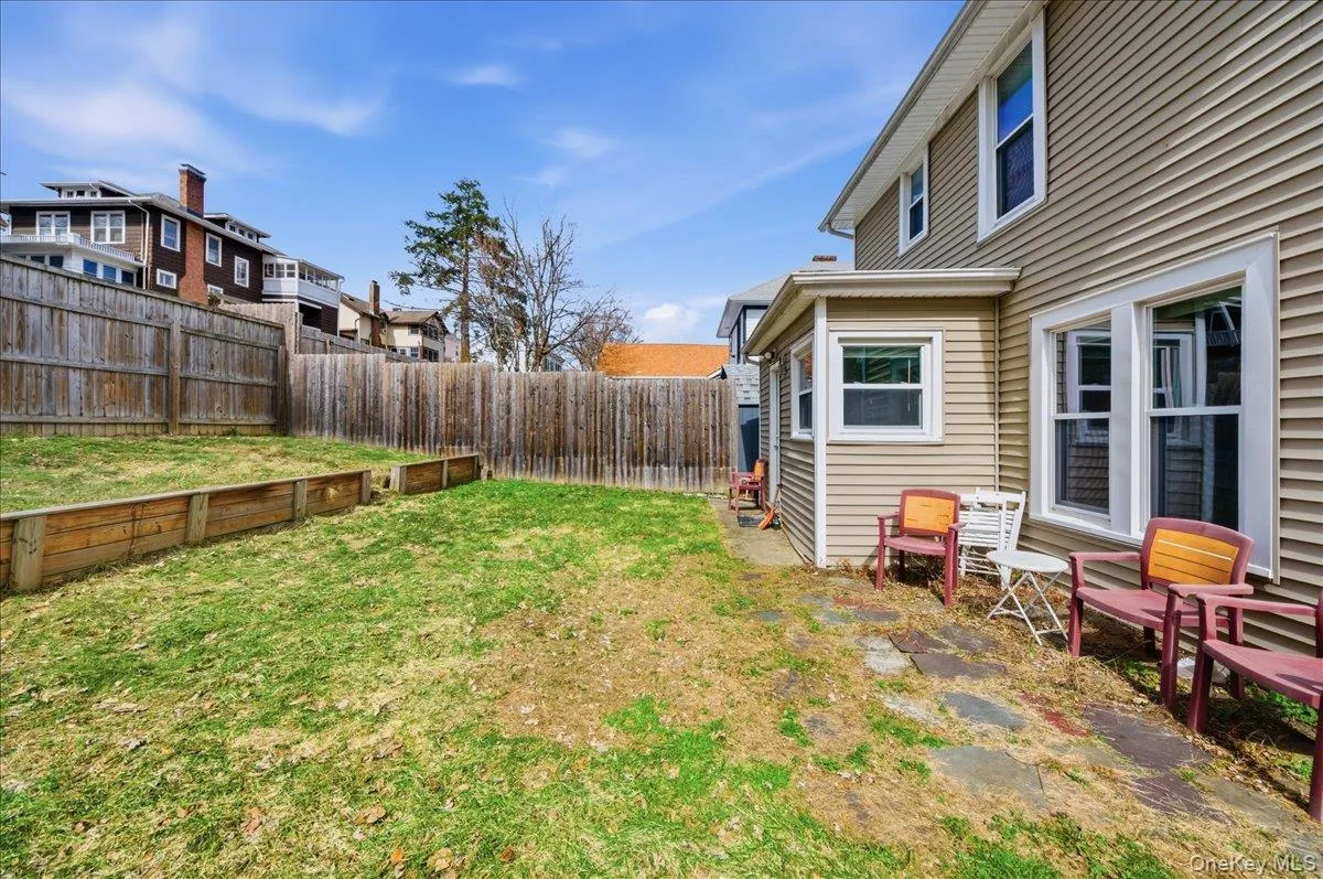 Partially fenced backyard with side patio Partially fenced backyard with side patio