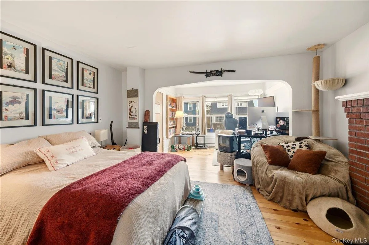 Bedroom with wood-type flooring and arched walkways Bedroom with wood-type flooring and arched walkways
