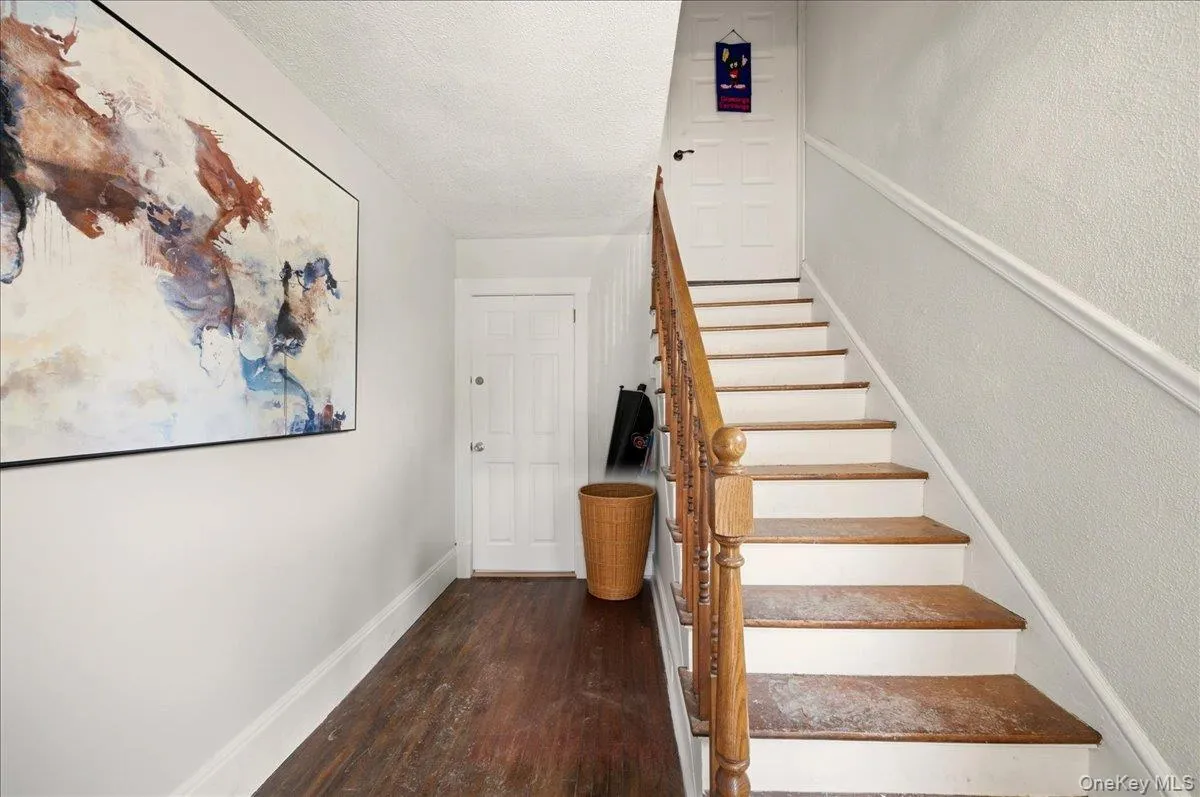 Stairs featuring wood finished floors. Ground level entryway. Stairs featuring wood finished floors. Ground level entryway.