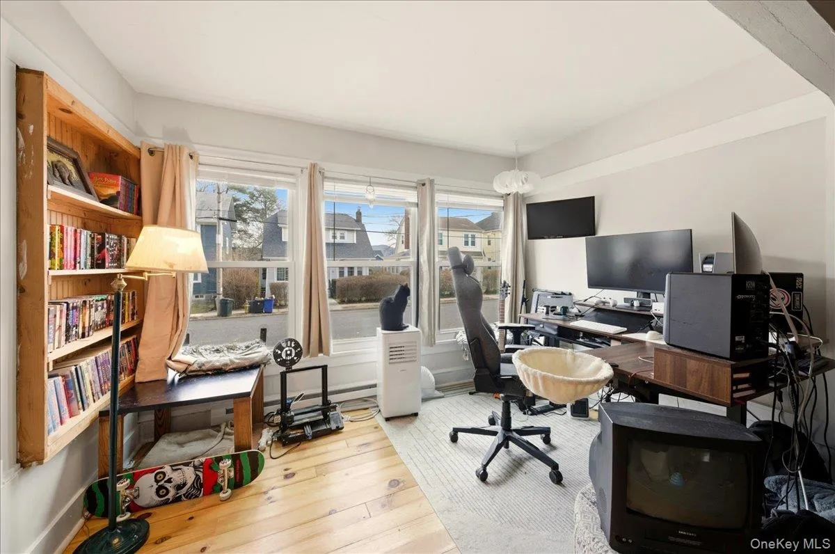 Office space of Primary Bedroom with healthy amount of natural light and light wood floors Office space of Primary Bedroom with healthy amount of natural light and light wood floors