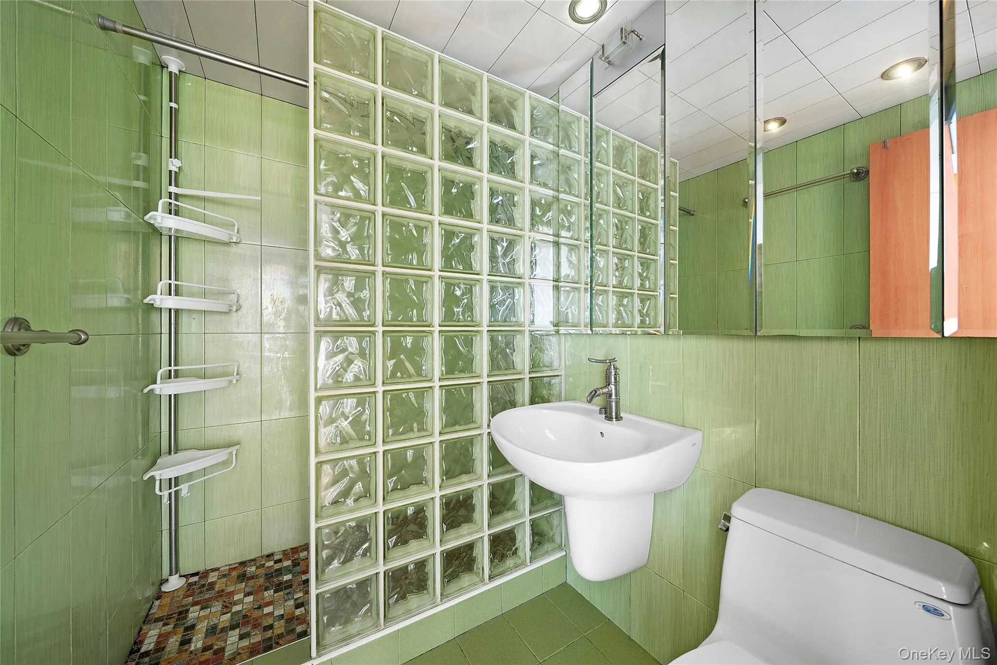 Full bathroom with tile walls and shower Full bathroom with tile walls and shower