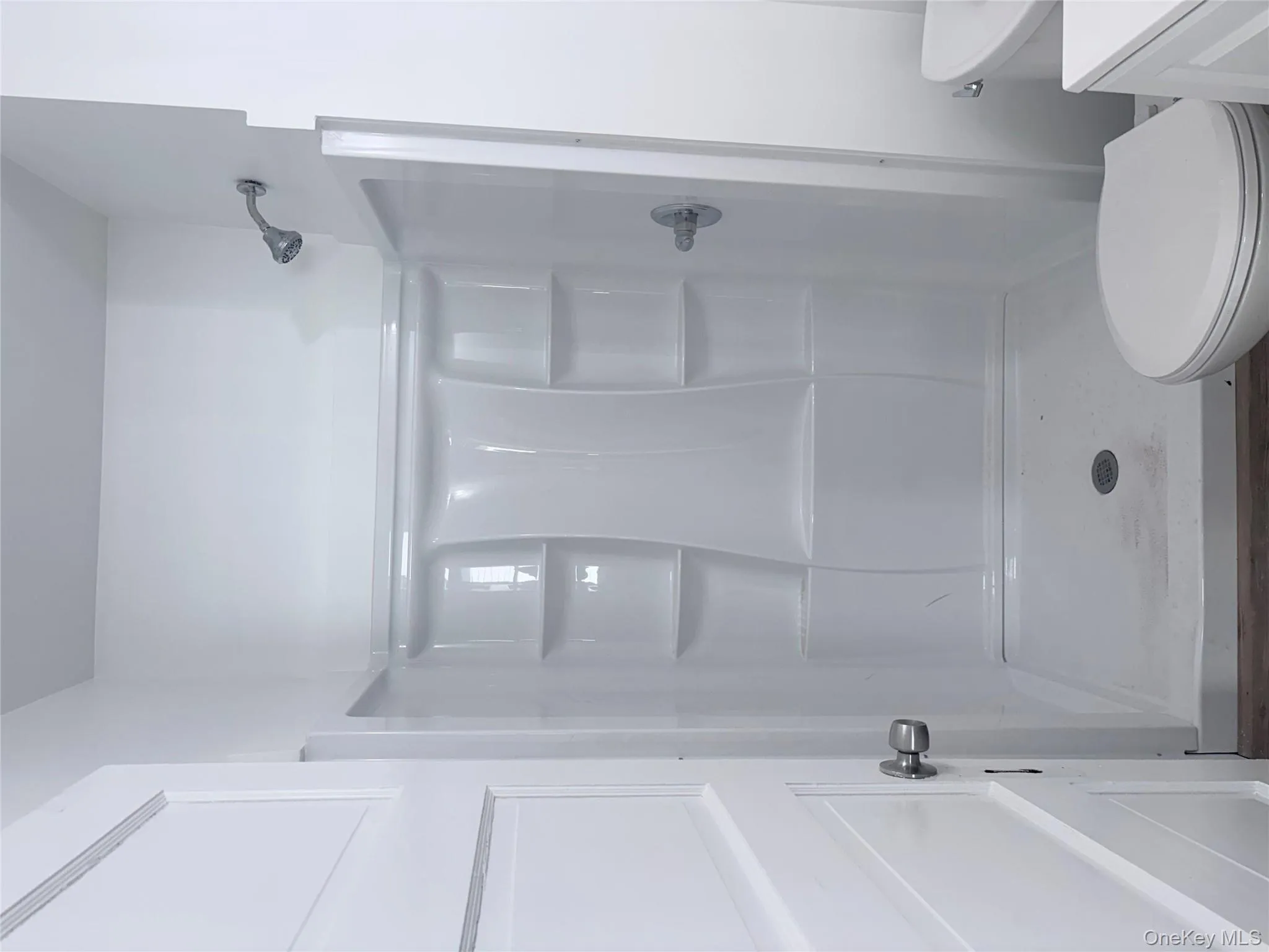 Bathroom featuring vanity, a shower stall, and vinyl floors Bathroom featuring vanity, a shower stall, and vinyl floors