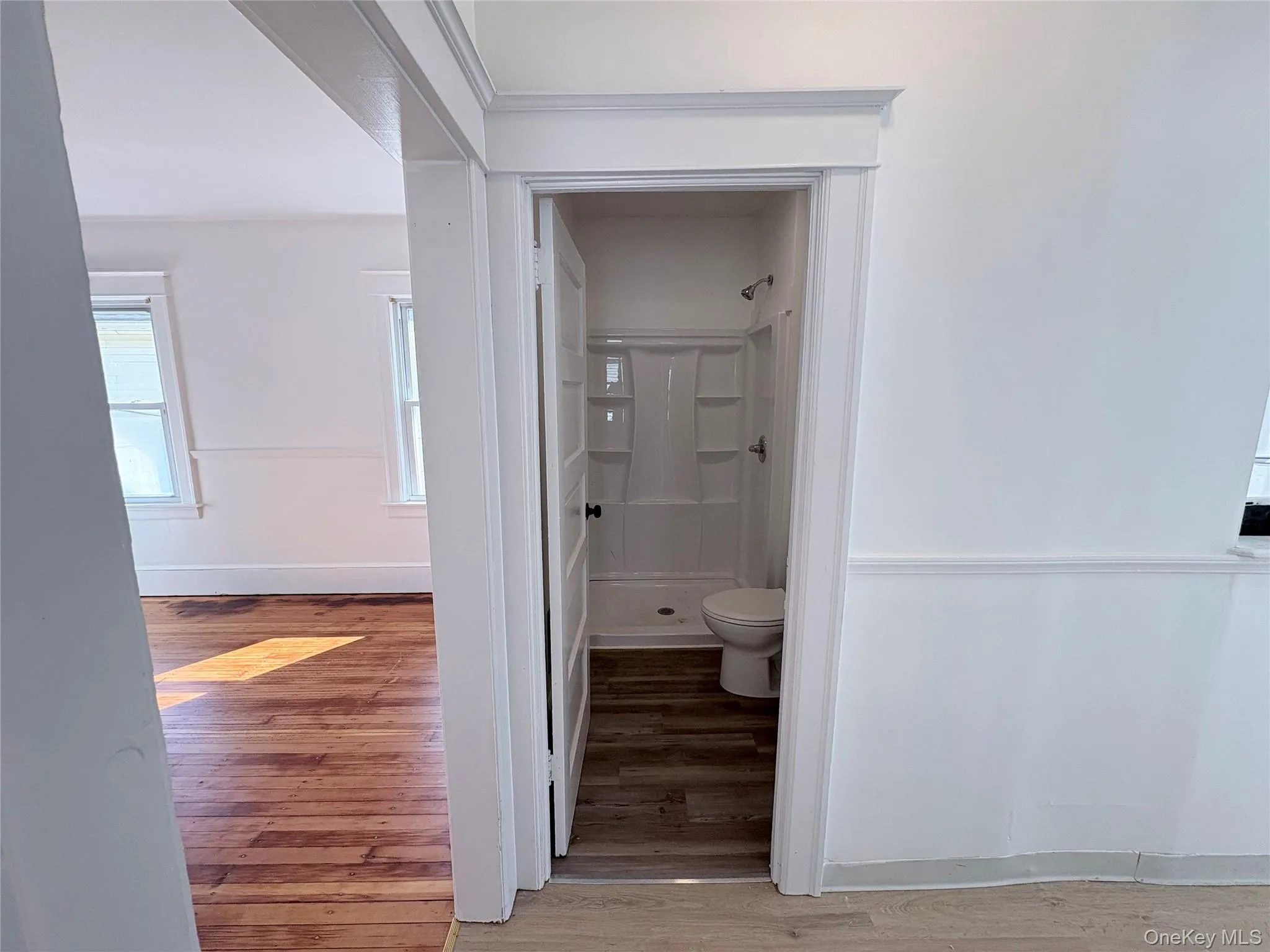 Bathroom with light vinyl flooring and shower. Bathroom with light vinyl flooring and shower.