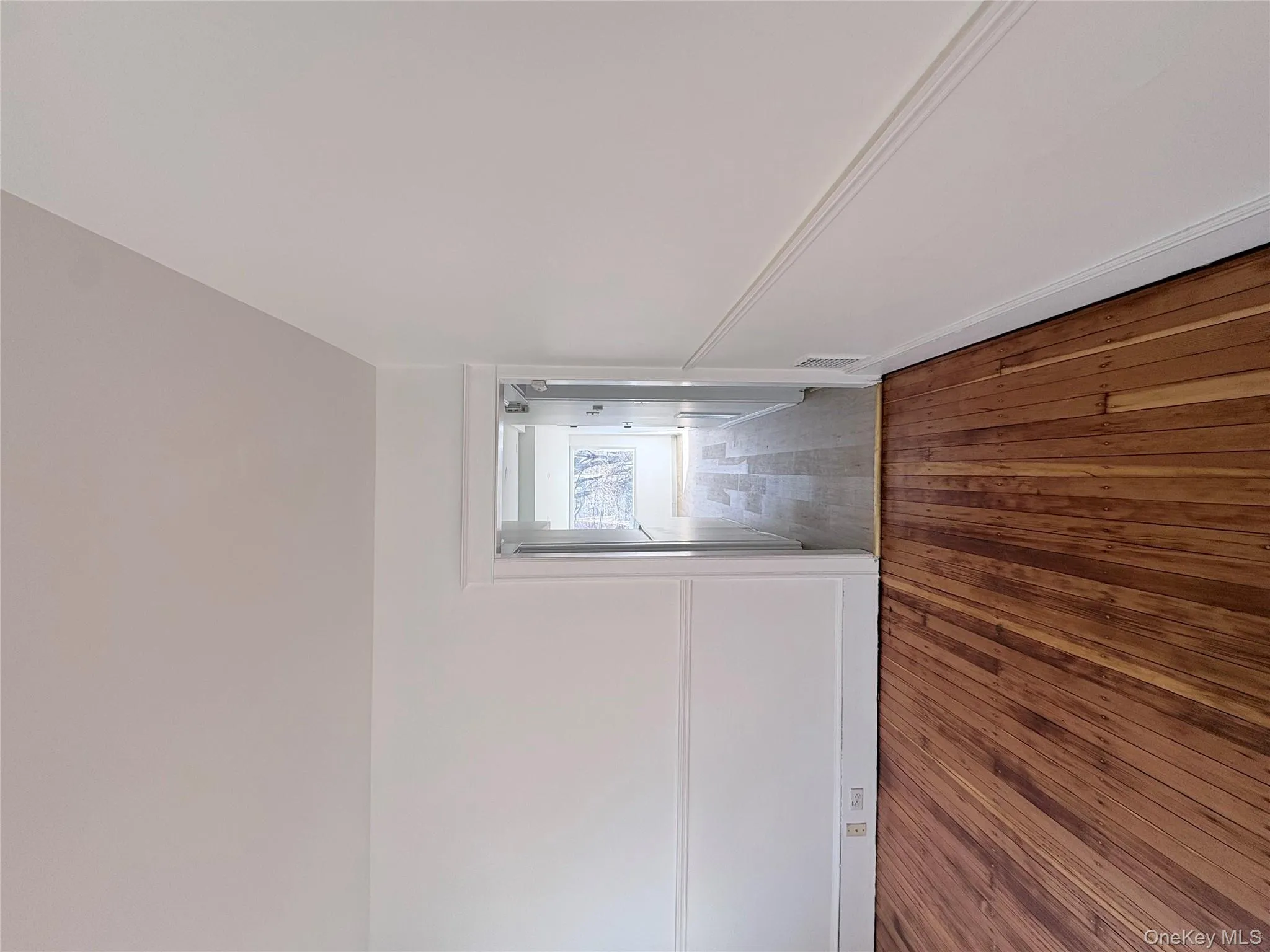 Living room featuring hardwood flooring and craftsman baseboards and moldings Living room featuring hardwood flooring and craftsman baseboards and moldings