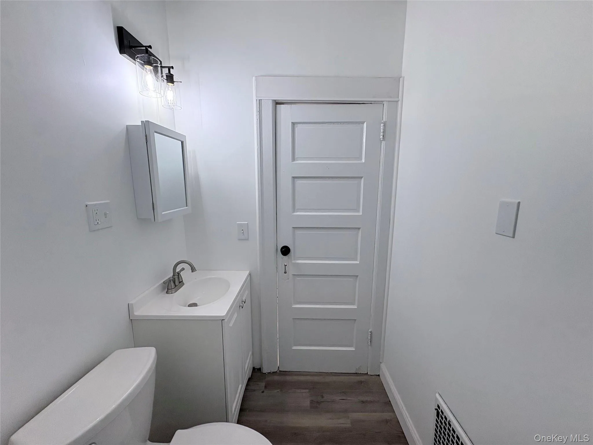 Bathroom with vanity and dark vinyl flooring Bathroom with vanity and dark vinyl flooring