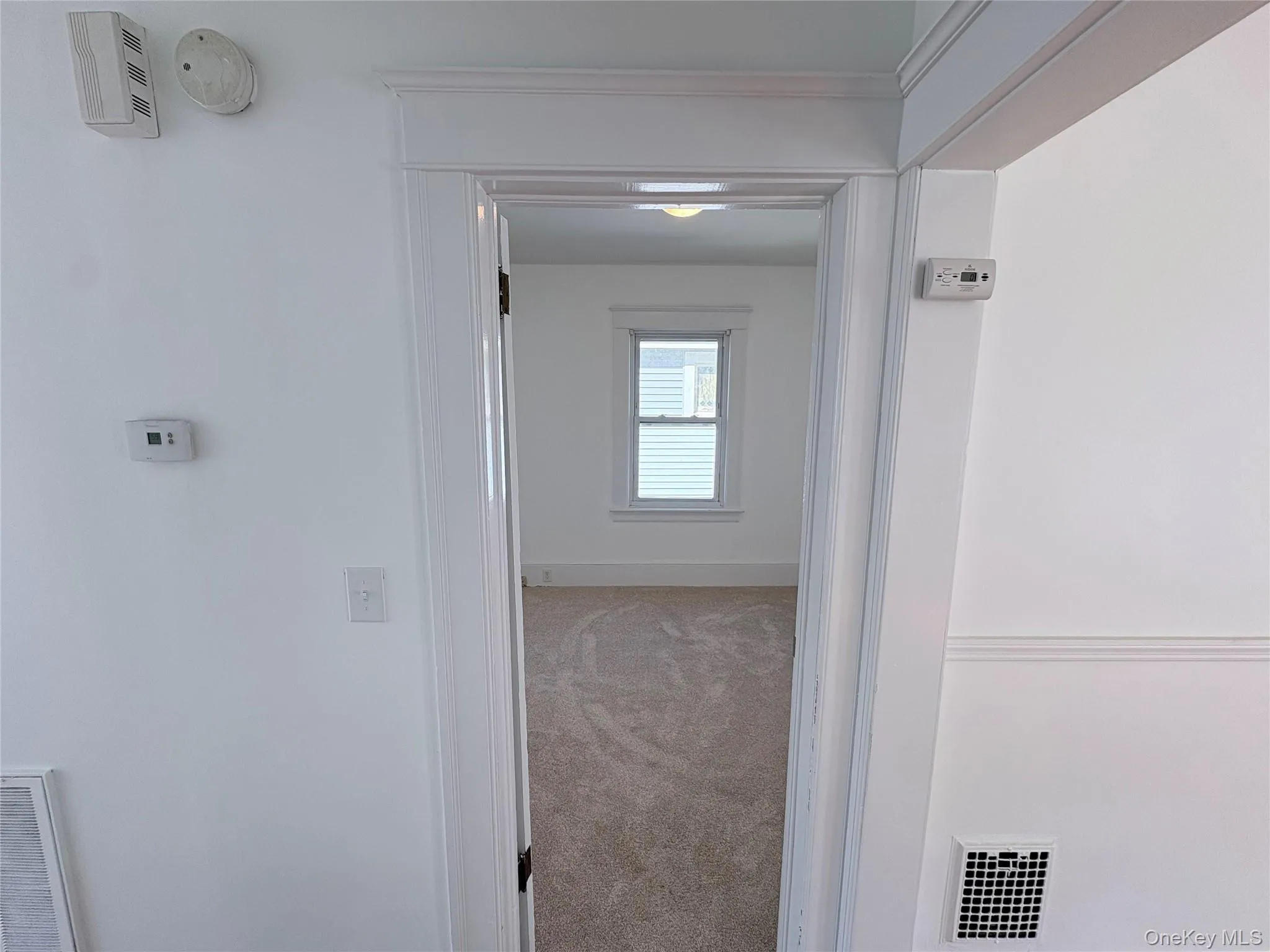 Bedroom 2: light colored carpet and natural light Bedroom 2: light colored carpet and natural light