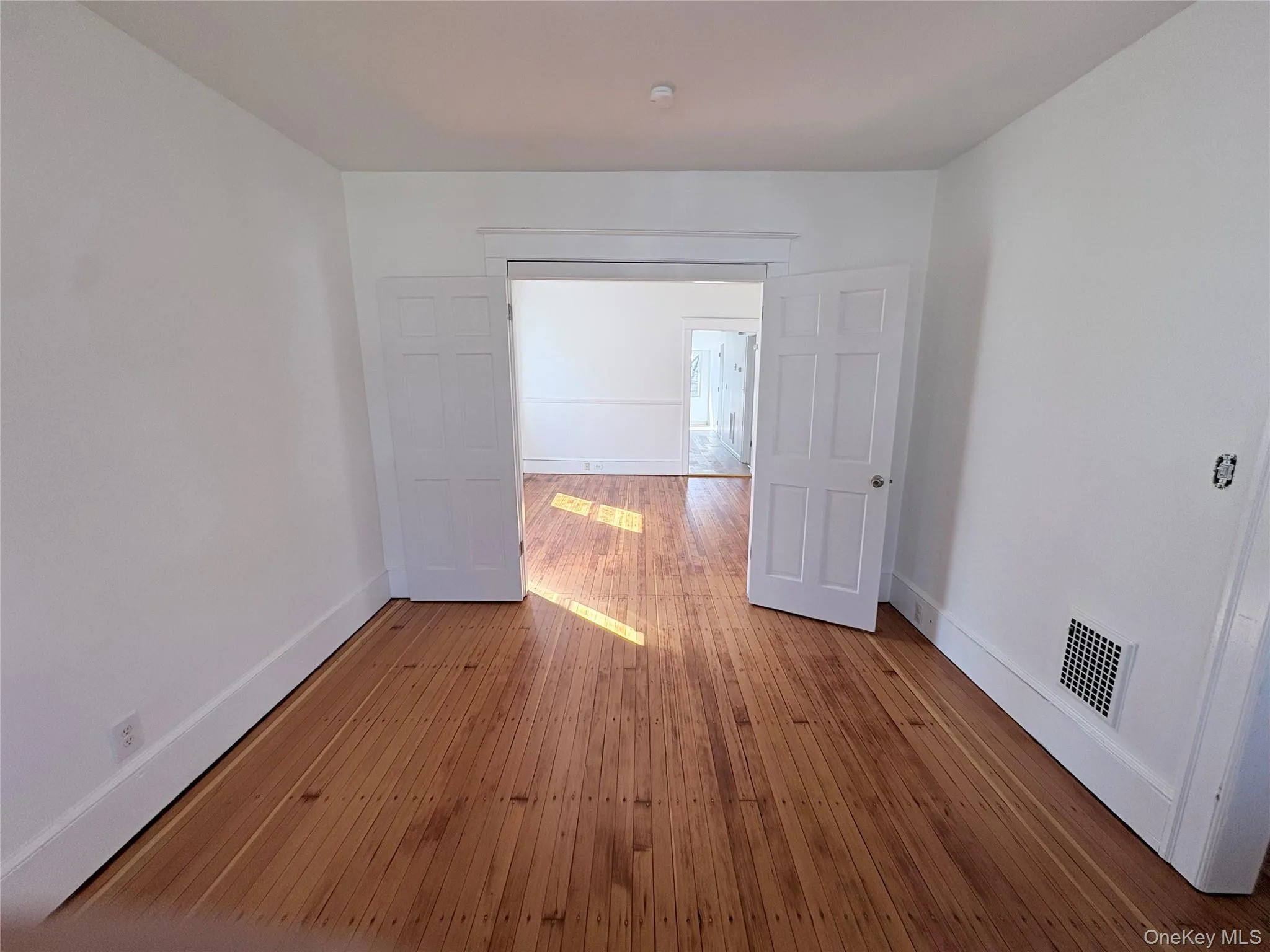 Living room with hardwood flooring and craftsman molding and baseboards Living room with hardwood flooring and craftsman molding and baseboards