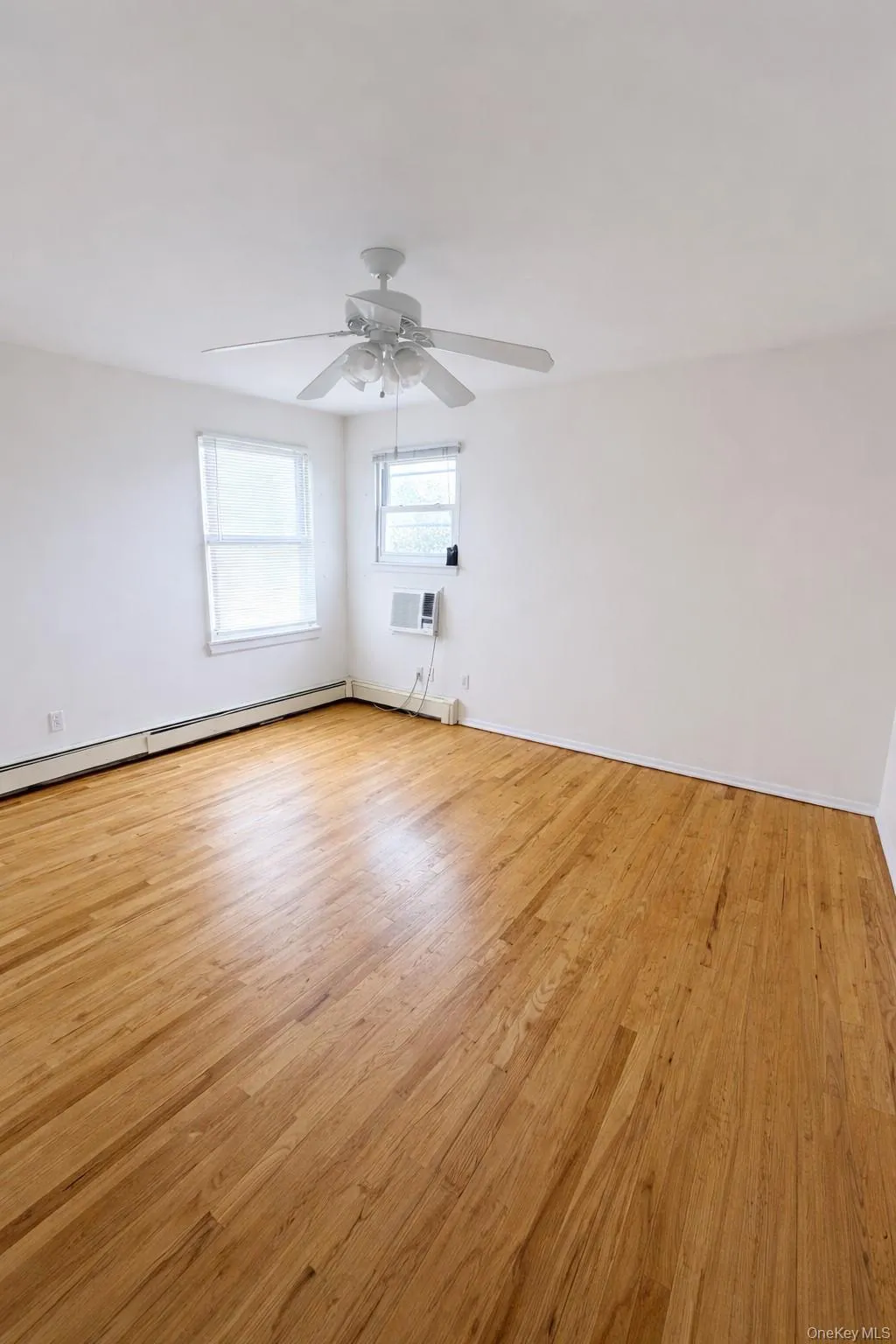 Sunlit and airy, this bedroom showcases beautiful hardwood floors and dual windows that bring in abundant natural light. The open layout offers flexibility for a full bedroom setup with room to spare. Sunlit and airy, this bedroom showcases beautiful hardwood floors and dual windows that bring in abundant natural light. The open layout offers flexibility for a full bedroom setup with room to spare.